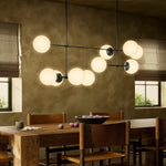 Featuring Armstrong Black Gunmetal Opal Matte Glass Linear Chandelier by Four Hands at Amethyst Home. Matte glass spheres seem to extend and reach across smooth brass rods. Each globe is individually blown, shaped and sculpted by hand through a one-hour process. Matte globes are specially manufactured to evenly diffuse light. The finish on the brass frame. Amethyst Home provides interior design, new home construction design consulting, vintage area rugs, and lighting in the Los Angeles metro area.