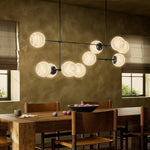 Featuring Armstrong Black Gunmetal Marbled Matte Glass Linear Chandelier by Four Hands at Amethyst Home. Marbled glass spheres seem to extend and reach across smooth brass rods. Each globe is individually blown, shaped and sculpted by hand through a one-hour process. The finish on the brass frame is achieved through a specialized process that turns the brass in. Amethyst Home provides interior design, new home construction design consulting, vintage area rugs, and lighting in the Miami metro area.