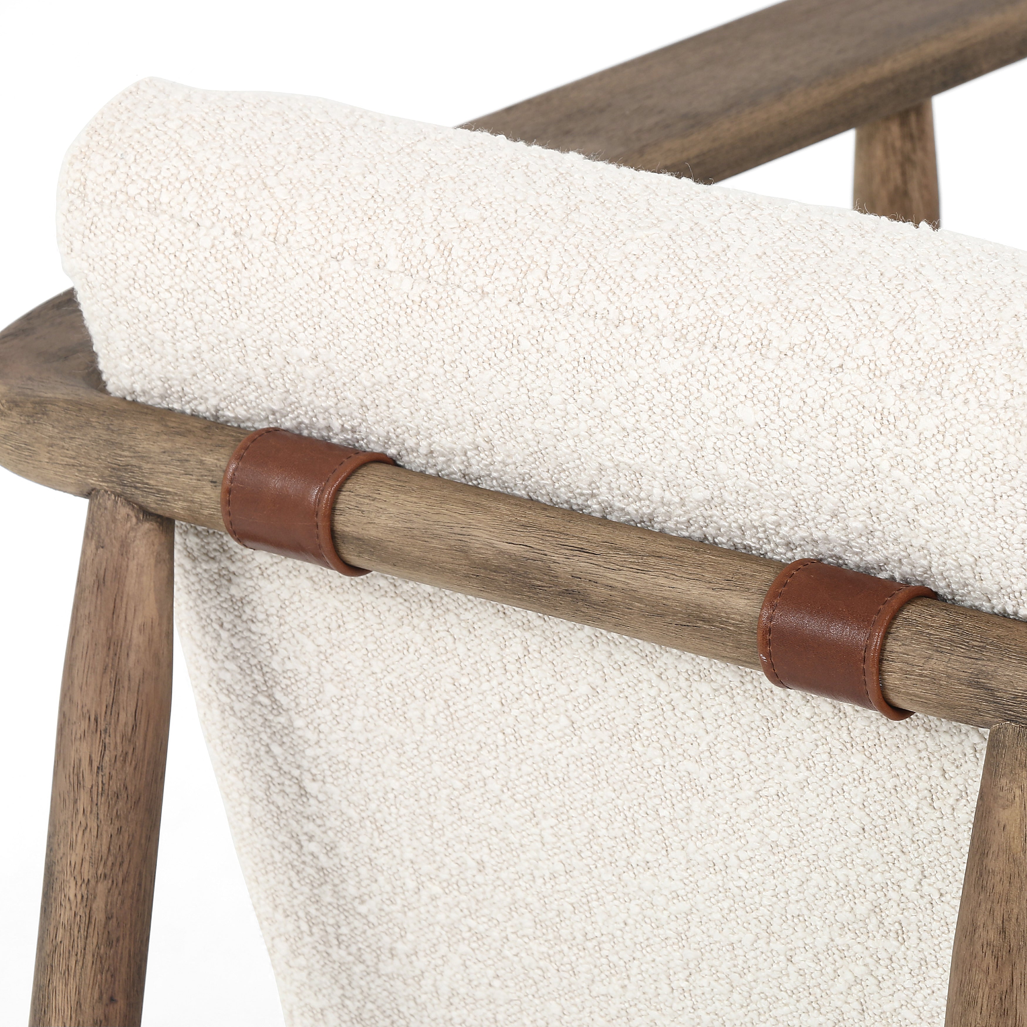 Featuring Arnett Chair by Four Hands at Amethyst Home. Textural cream boucle seating offers a sumptuous sit, with complementary wire-brushed parawood framing forming a slim U shape. Two posterior top-grain leather straps add a stylish finishing touch. Performance fabrics are specially created to withstand spills, stains, high traffic and wear, ensuring long-term comfort and unmatched . Amethyst Home provides interior design, new construction, custom furniture and area rugs in the Boston metro area