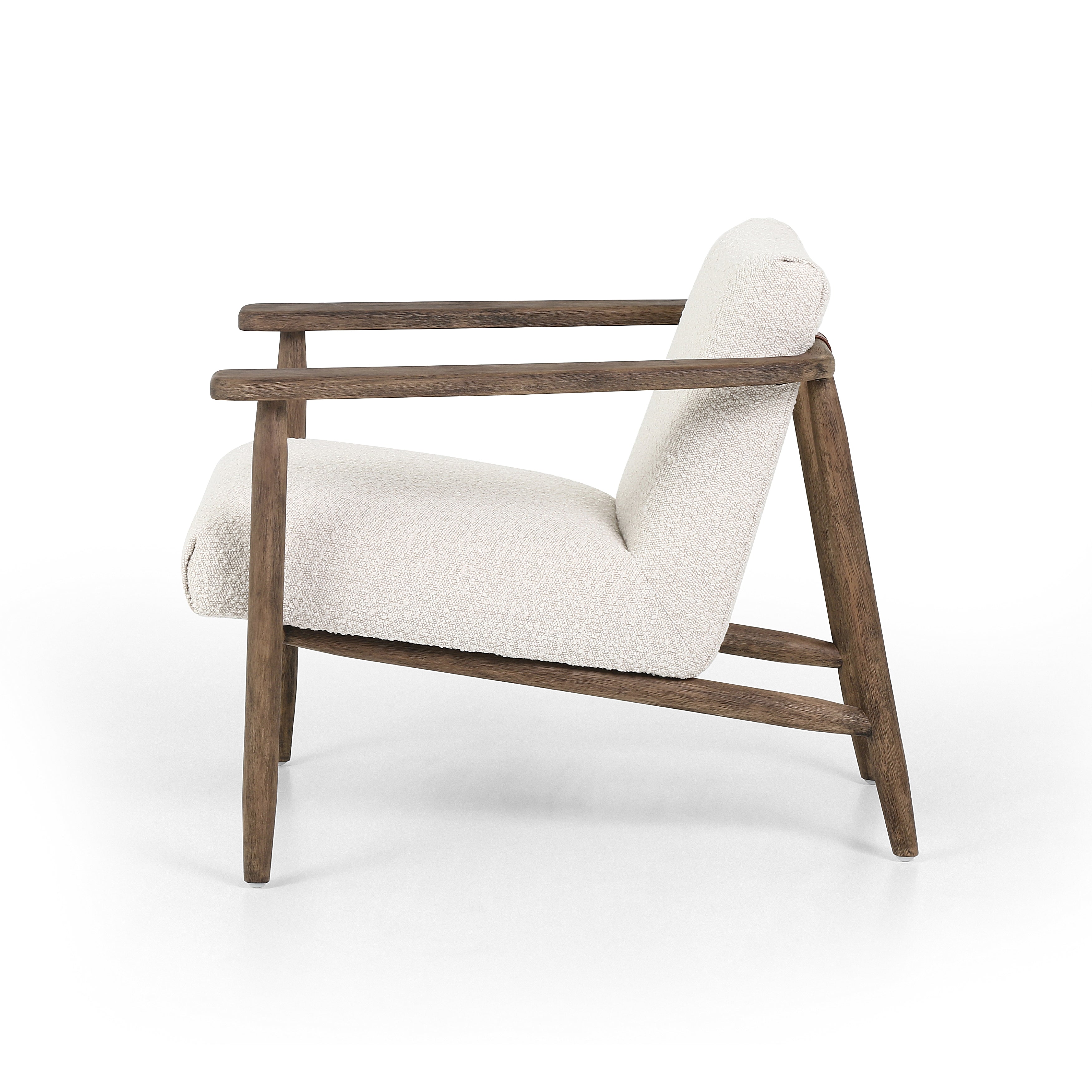 Featuring Arnett Chair by Four Hands at Amethyst Home. Textural cream boucle seating offers a sumptuous sit, with complementary wire-brushed parawood framing forming a slim U shape. Two posterior top-grain leather straps add a stylish finishing touch. Performance fabrics are specially created to withstand spills, stains, high traffic and wear, ensuring long-term comfort and unmatch. Amethyst Home provides interior design, new construction, custom furniture and area rugs in the Park City metro area