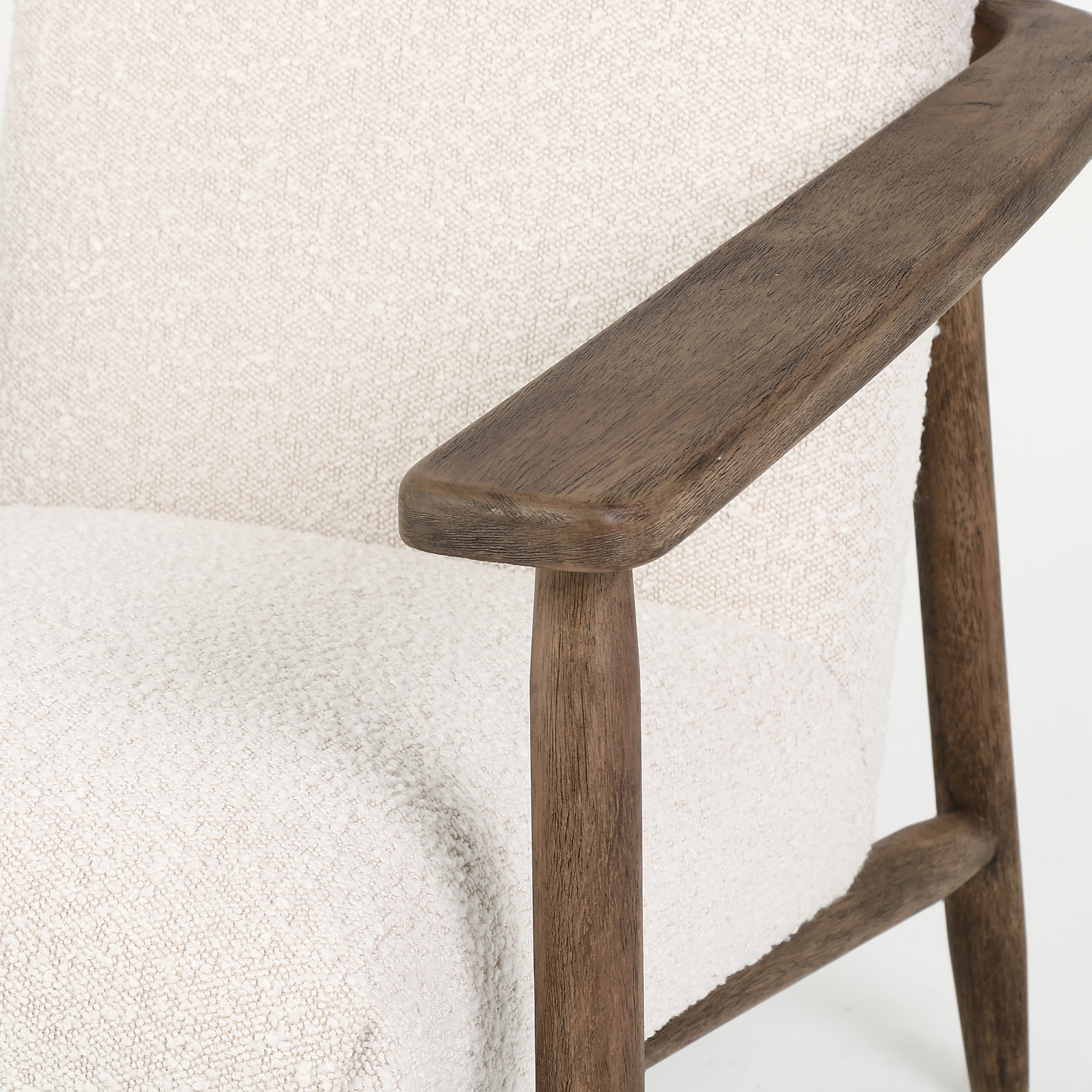 Featuring Arnett Chair by Four Hands at Amethyst Home. Textural cream boucle seating offers a sumptuous sit, with complementary wire-brushed parawood framing forming a slim U shape. Two posterior top-grain leather straps add a stylish finishing touch. Performance fabrics are specially created to withstand spills, stains, high traffic and wear, ensuring long-term comfort and unmatched d. Amethyst Home provides interior design, new construction, custom furniture and area rugs in the Tampa metro area