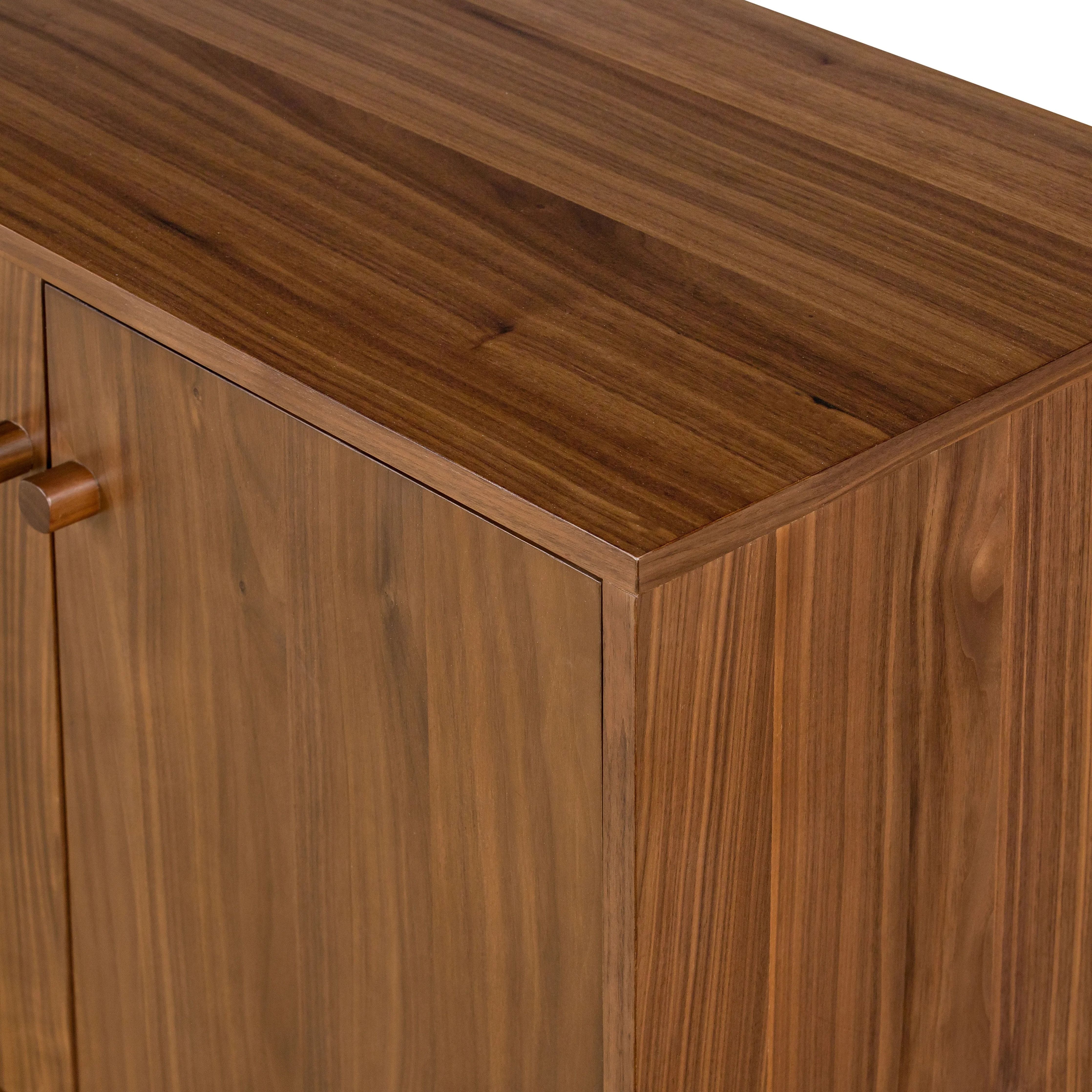 Inspired by campaign-style furniture of the 1800s â€” packable pieces first designed for traveling military use â€” a simply shaped sideboard of natural walnut features a subtly inset top and rounded legs, finished with wooden hardware Amethyst Home provides interior design, new home construction design consulting, vintage area rugs, and lighting in the Dallas metro area.