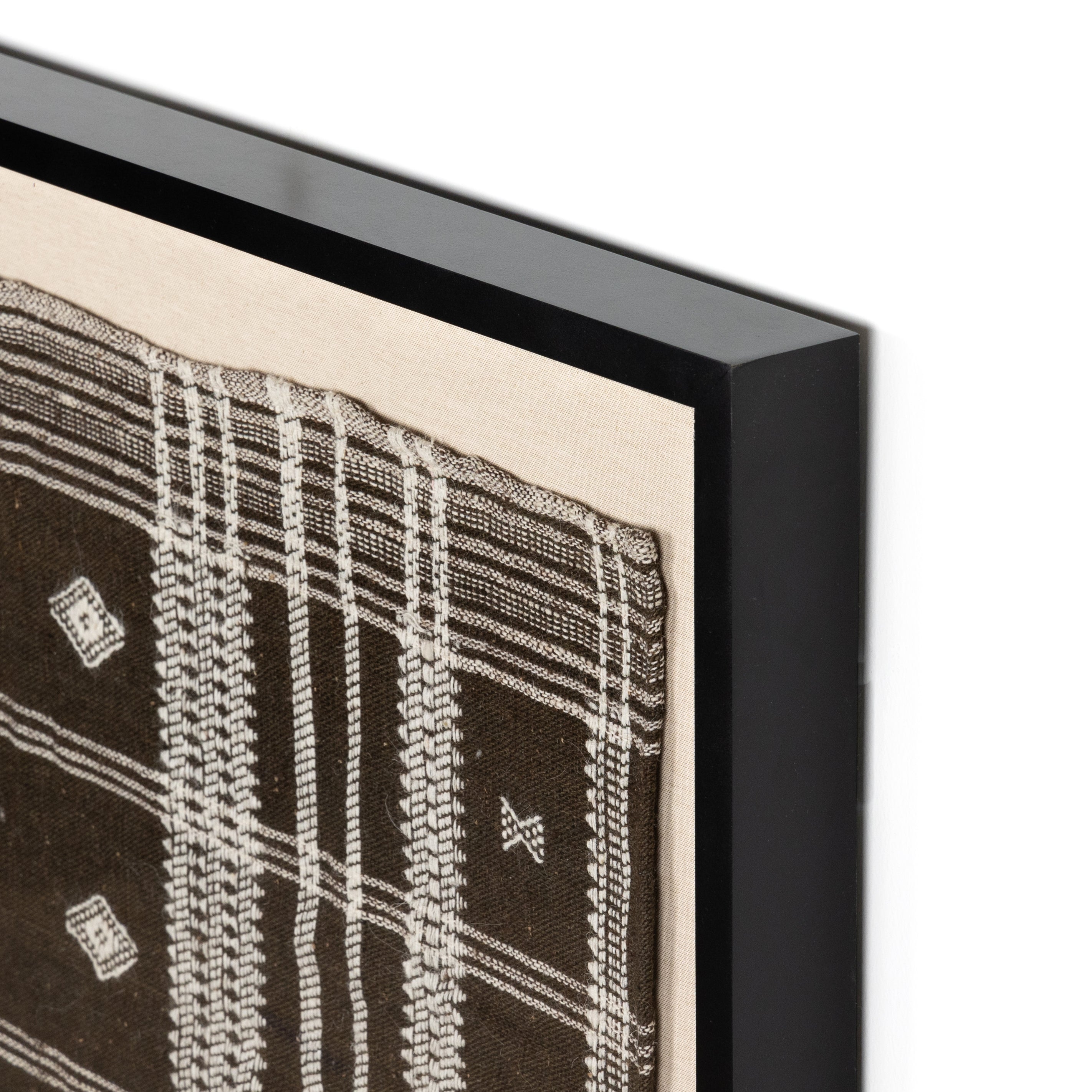 Featuring Bhujodi Chocolate Textile by Four Hands at Amethyst Home. A Bhujodi-style textile is framed within rustic walnut for a gallery-quality look. Handmade in Austin, Texas.Overall Dimensions: 75"W x 2.50"L x 35"HColors: Black 2.5 Maple, Bhujodi ChocolateMaterials: American Maple, 100% Wool. Amethyst Home provides interior design, new home construction design consulting, vintage area rugs, and lighting in the Boston metro area.