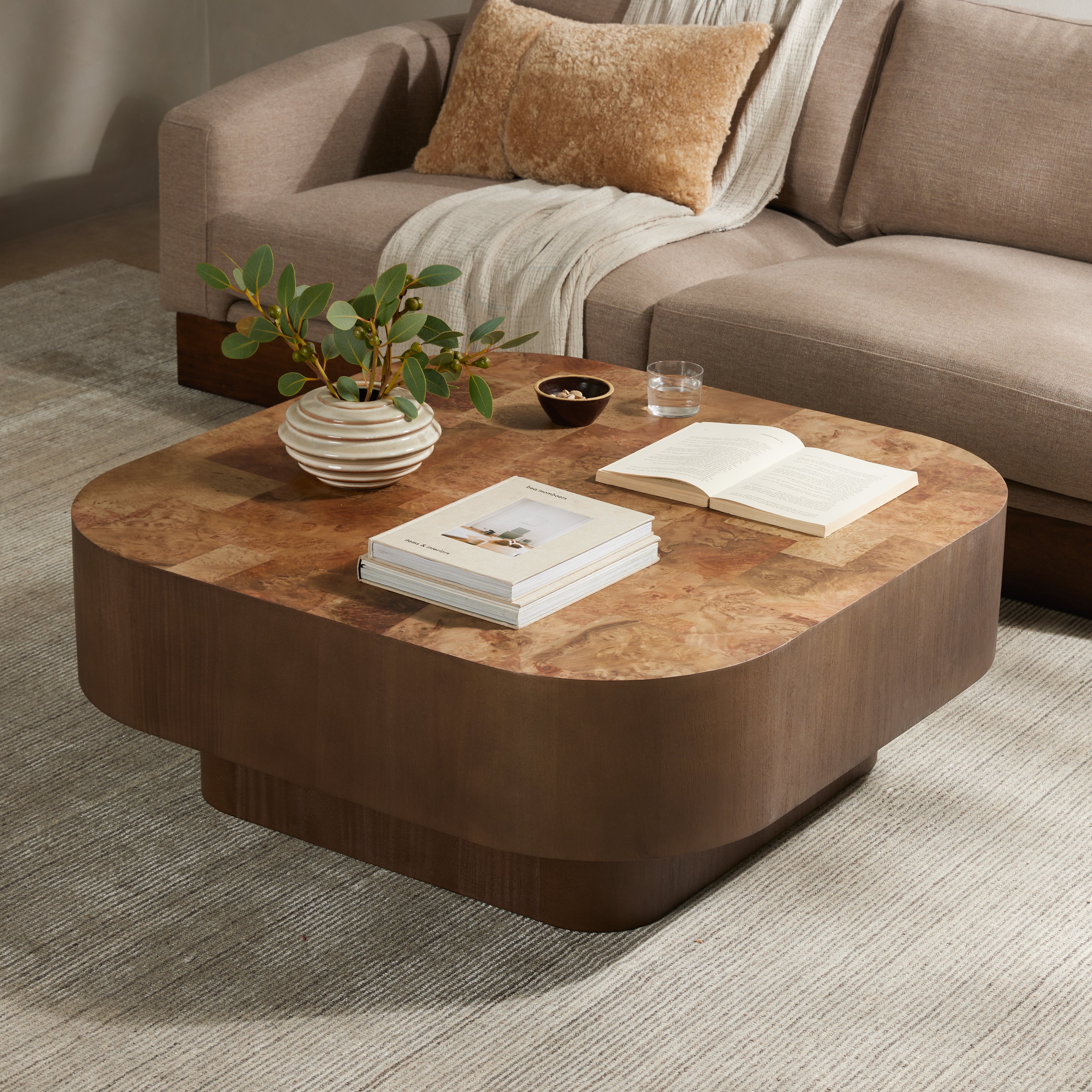 Made from warm-toned burl, a soft-squared tabletop features a patchwork pattern to bring novel movement to the modern coffee table. Veneer sides and an inset base complete a beautifully light look. Amethyst Home provides interior design, new construction, custom furniture, and area rugs in the Washington metro area.