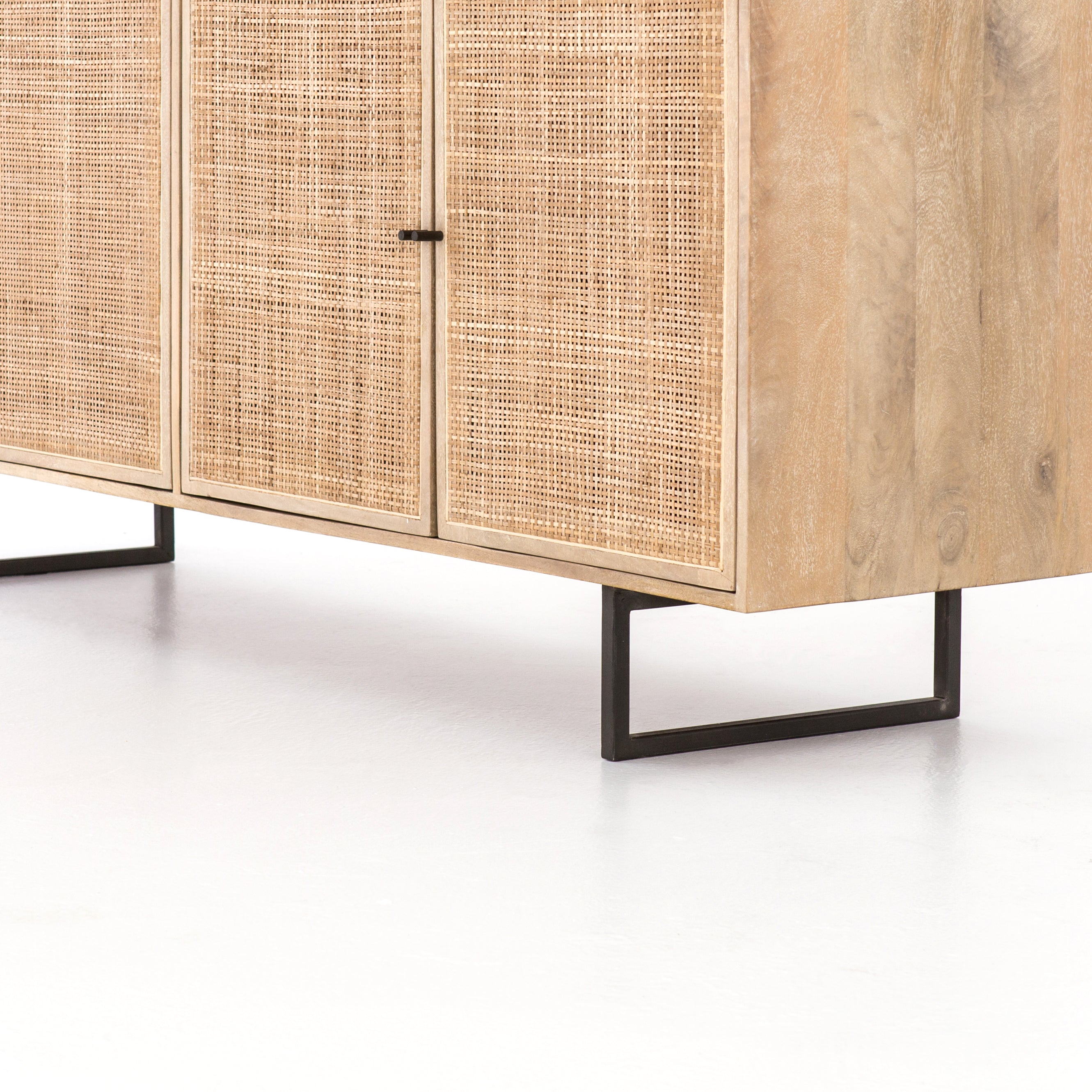 Mid-century-inspired style with an organic twist. Surrounded by mango casing, light cane weaves for a fresh look with natural depth. Angular gunmetal-finished iron legs offer an intriguing contrast of texture and tone. Amethyst Home provides interior design, new construction, custom furniture, and area rugs in the Seattle metro area.