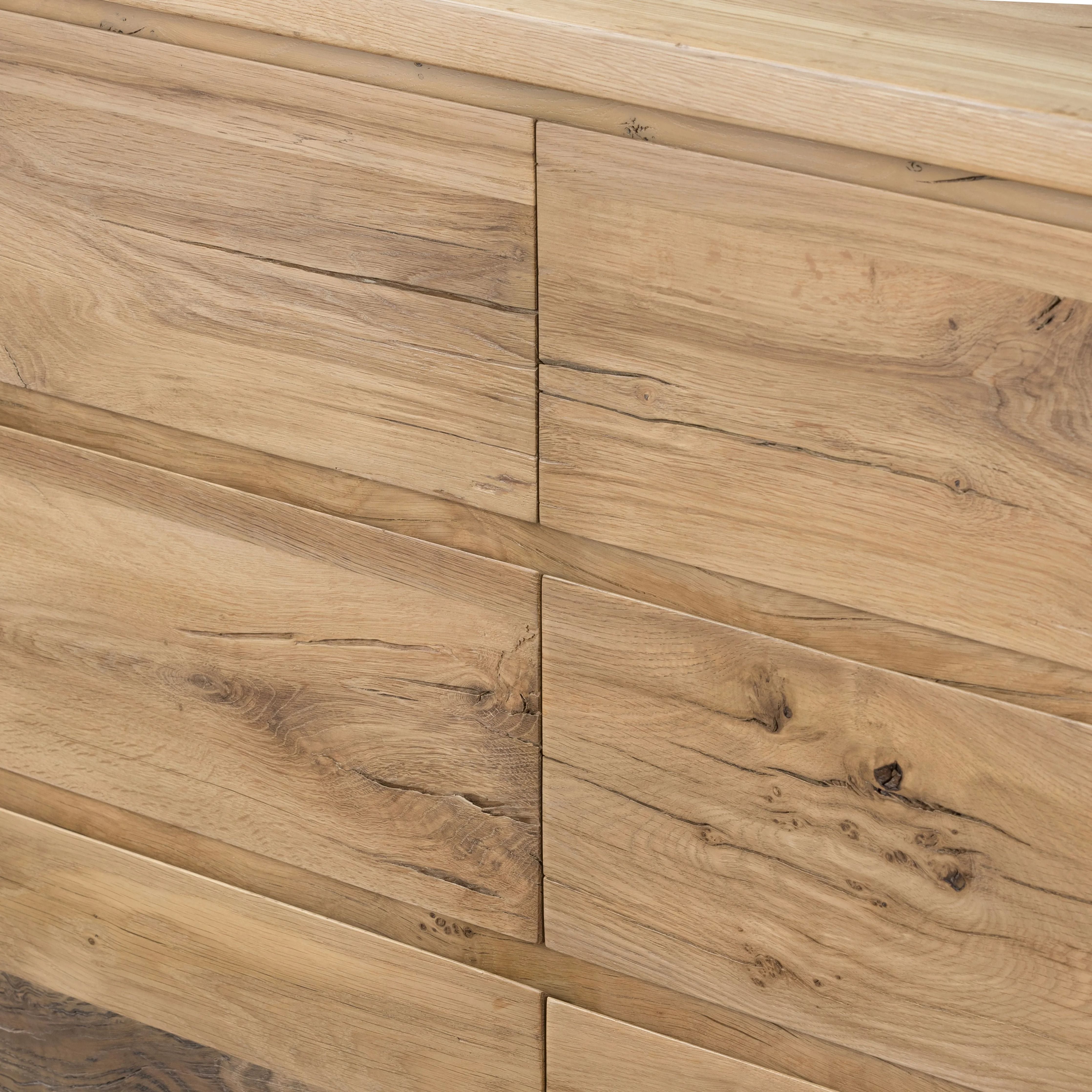 Designed by Thomas Bina and Ronald Sasson, a design partnership blending both modern minimalist and Brazilian influences. This grand-scale dresser is crafted from natural reclaimed French oak with plenty of graining, cracking and movement across the drawer fronts. Detailed with angled legs and exposed joinery on the top. Amethyst Home provides interior design, new home construction design consulting, vintage area rugs, and lighting in the Des Moines metro area.