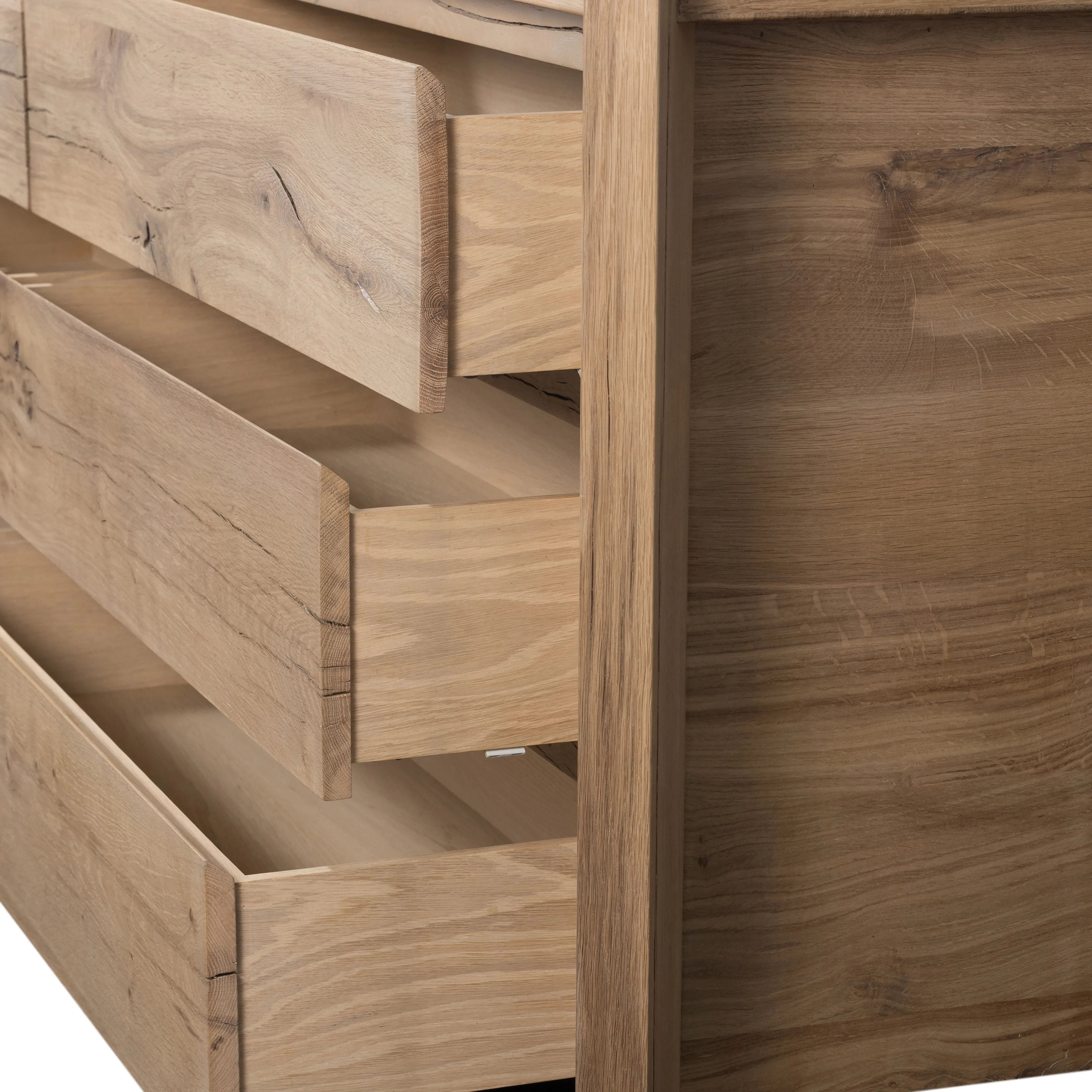 Designed by Thomas Bina and Ronald Sasson, a design partnership blending both modern minimalist and Brazilian influences. This grand-scale dresser is crafted from natural reclaimed French oak with plenty of graining, cracking and movement across the drawer fronts. Detailed with angled legs and exposed joinery on the top. Amethyst Home provides interior design, new home construction design consulting, vintage area rugs, and lighting in the Laguna Beach metro area.