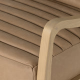 A dramatically shaped midcentury silhouette, modernized with channel tufting. Upholstered in a nude hue top-grain leather with natural whitewashed ash framing for a clean, monochromatic look. A push recliner takes this forward-thinking lounger to the next level. Amethyst Home provides interior design, new construction, custom furniture, and area rugs in the Austin metro area.