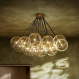 Featuring Cloud Black Cord Burnished Brass Chandelier by Four Hands at Amethyst Home. Clear glass bulbs dangle for a statement-making centerpiece. Each globe is individually blown, shaped and sculpted by hand through a one-hour process. Brass and glass are 98% recyclable. Designed and sustainably crafted in Poland by Schwung.
Overall Dimensions : 47.00"w x . Amethyst Home provides interior design, new home construction design consulting, vintage area rugs, and lighting in the Nashville metro area.