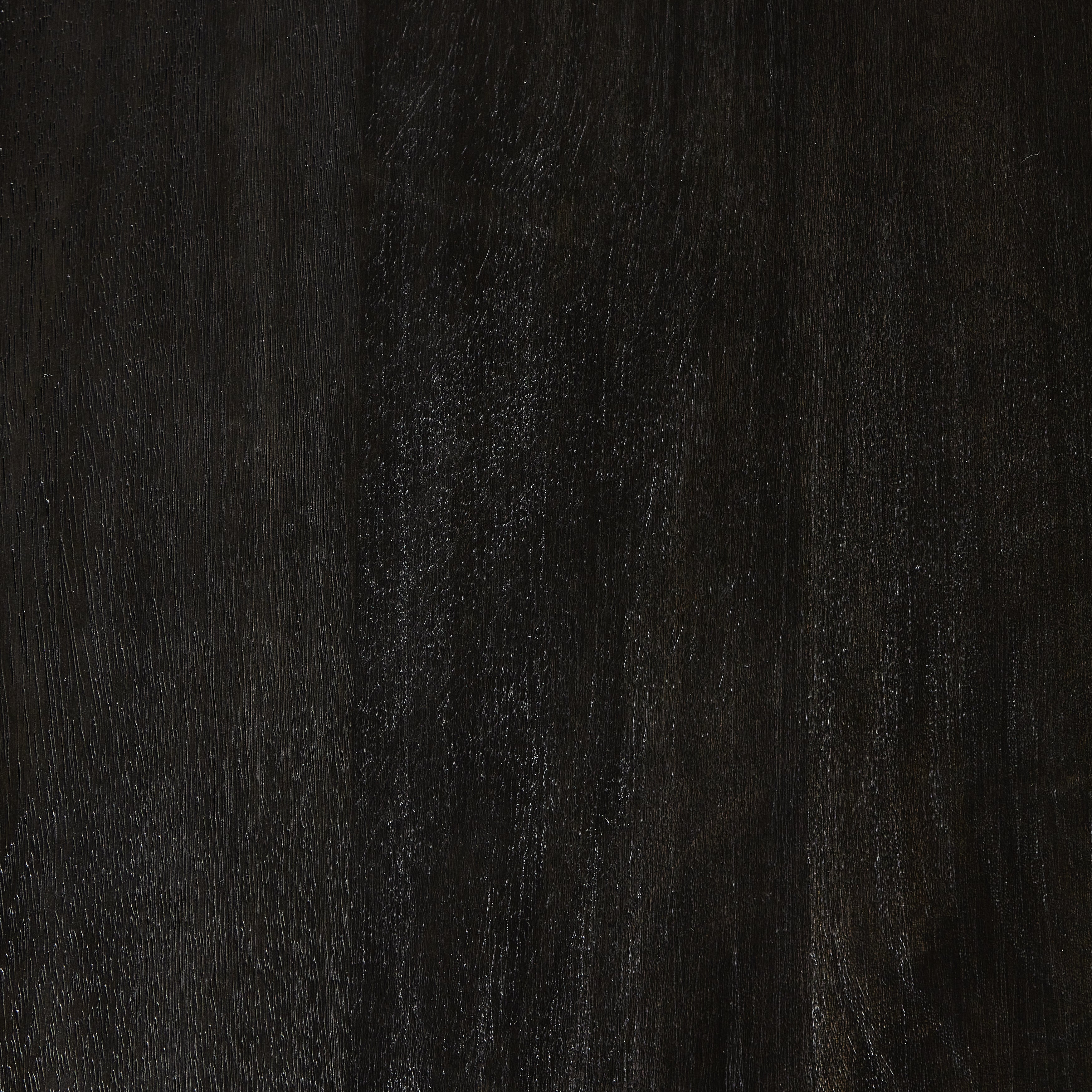 A rounded table of solid mango wood forms purposefully burnished edges, producing a warm black patina for the home dining table. Amethyst Home provides interior design, new construction, custom furniture, and area rugs in the San Diego metro area.