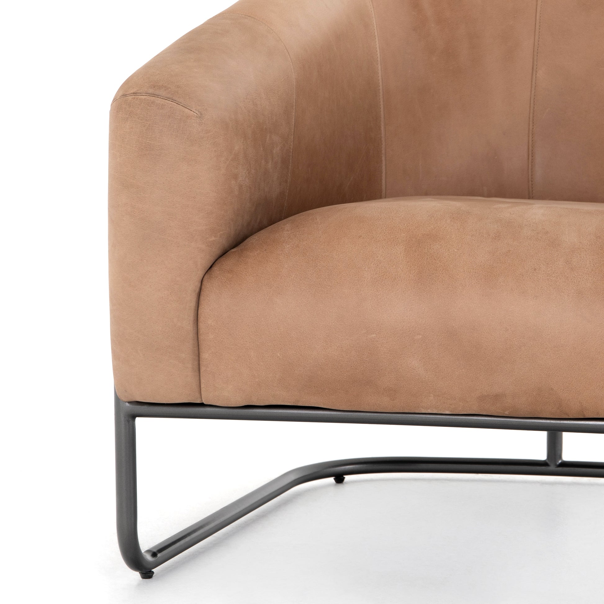 Deco-driven elegance. A fresh take on the traditional cigar chair, impeccably tailored tan top-grain leather forms a curvy U shape, with solid parawood detailing adding interest to gunmetal-finished iron framing. Amethyst Home provides interior design, new construction, custom furniture, and area rugs in the Newport Beach metro area.
