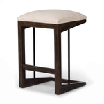 Featuring Finn Sienna Brown Oak Counter Stool by Four Hands at Amethyst Home. A stunner from every angle, this architecturally inspired stool features an angular base crafted from solid oak with two iron rods for added support and visual interest. Seat is upholstered in a linen/cotton/poly blend performance fabric with subtle texture throughout. Performance. Amethyst Home provides interior design, new home construction design consulting, vintage area rugs, and lighting in the Calabasas metro area.