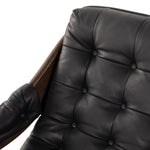 A Seventies-era style inspired by a flea market find, a dramatically tufted sling seat of black top-grain leather angles at the just-right pitch for total comfort, with wide, brown ash framing. Amethyst Home provides interior design, new home construction design consulting, vintage area rugs, and lighting in the San Diego metro area.