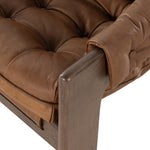 Featuring Halston Heirloom Sienna Chair by Four Hands at Amethyst Home. A Seventies-era style inspired by a flea market find, a dramatically tufted sling seat of black top-grain leather angles at the just-right pitch for total comfort, with wide, brown ash framing. Sourced from one of the oldest family-owned tanneries in Italy's Bassano del Grappa, heirlo. Amethyst Home provides interior design, new home construction design consulting, vintage area rugs, and lighting in the Los Angeles metro area.