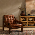 Featuring Halston Heirloom Sienna Chair by Four Hands at Amethyst Home. A Seventies-era style inspired by a flea market find, a dramatically tufted sling seat of black top-grain leather angles at the just-right pitch for total comfort, with wide, brown ash framing. Sourced from one of the oldest family-owned tanneries in Italy's Bassano del Grappa, heirloom . Amethyst Home provides interior design, new home construction design consulting, vintage area rugs, and lighting in the Portland metro area.