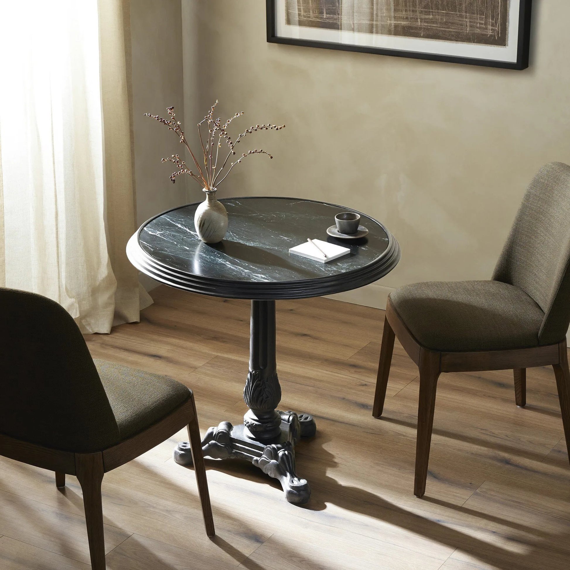 For a fresh take on classic Parisian styling, an ornate cast iron base is topped with black marble.Collection: Rockwel Amethyst Home provides interior design, new home construction design consulting, vintage area rugs, and lighting in the Boston metro area.