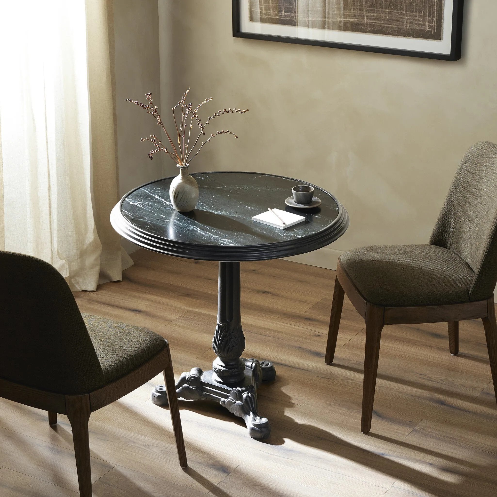 For a fresh take on classic Parisian styling, an ornate cast iron base is topped with black marble.Collection: Rockwel Amethyst Home provides interior design, new home construction design consulting, vintage area rugs, and lighting in the Boston metro area.