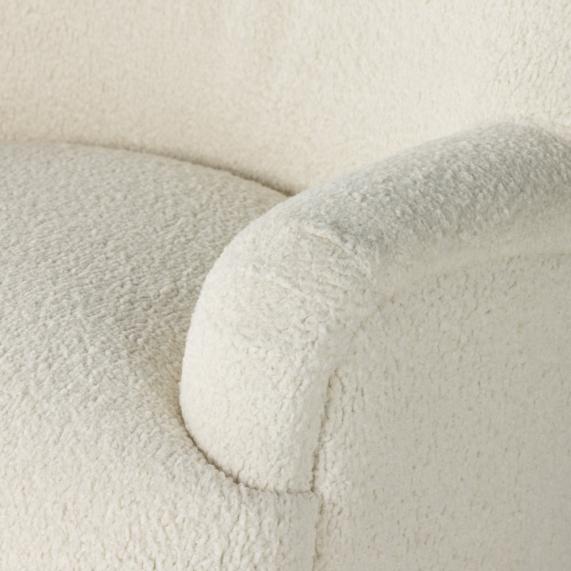 Kadon Natural Swivel Chair is a high wing back pairs with softly rolled arms for a curvy look and supportive sit. Cream-colored shearling-upholstered seating tops a 360-degree swivel. Amethyst Home provides interior design services, furniture, rugs, and lighting in the Salt Lake City metro area.