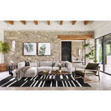 Wide, vertical channels and low styling speaks to modish Italian influence. Sandstone-colored covering and modular components allow for versatility in any space. Left arm facing chaise to matching sectional. Amethyst Home provides interior design, new home construction design consulting, vintage area rugs, and lighting in the Houston metro area.