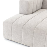 Wide, vertical channels and low styling speaks to modish Italian influence. Sandstone-colored covering and modular components allow for versatility in any space. Left arm facing chaise to matching sectional. Amethyst Home provides interior design, new home construction design consulting, vintage area rugs, and lighting in the Monterey metro area.
