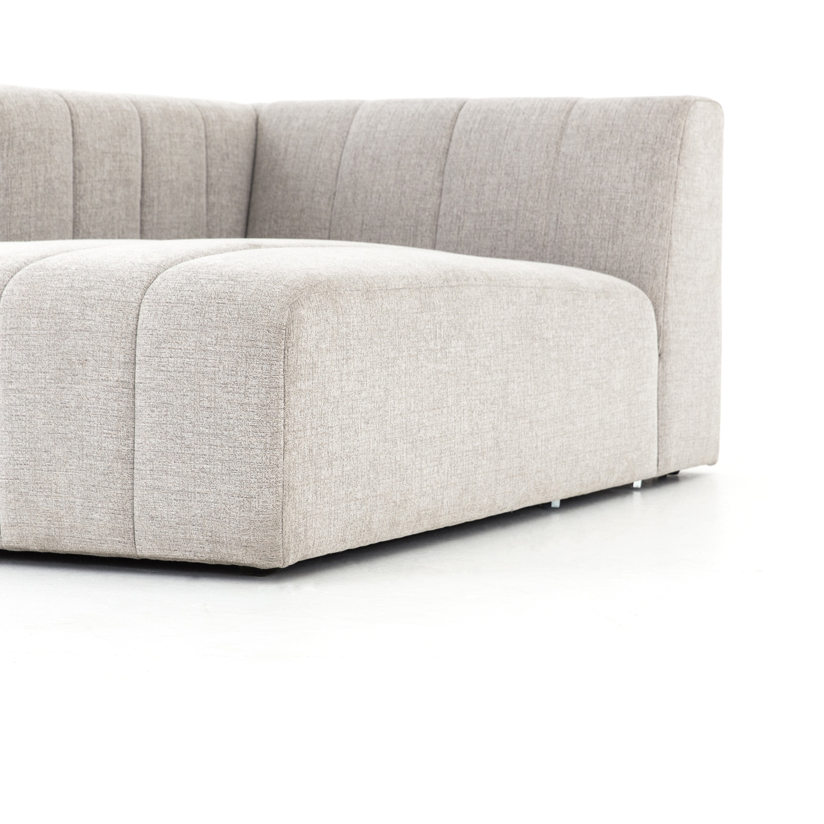 Wide, vertical channels and low styling speaks to modish Italian influence. Sandstone-colored covering and modular components allow for versatility in any space. Left arm facing chaise to matching sectional. Amethyst Home provides interior design, new home construction design consulting, vintage area rugs, and lighting in the San Diego metro area.