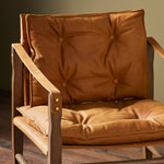 This material-driven take on safari styling features cognac-hued Italian-designed leather that's been lightly sanded and buffed by hand for a suede-like feel. With a tufted sling-style seat, strap arm and pivot back, this vintage-feeling accent chair makes a chic statement wherever it's styled. Amethyst Home provides interior design, new construction, custom furniture, and area rugs in the Austin metro area.