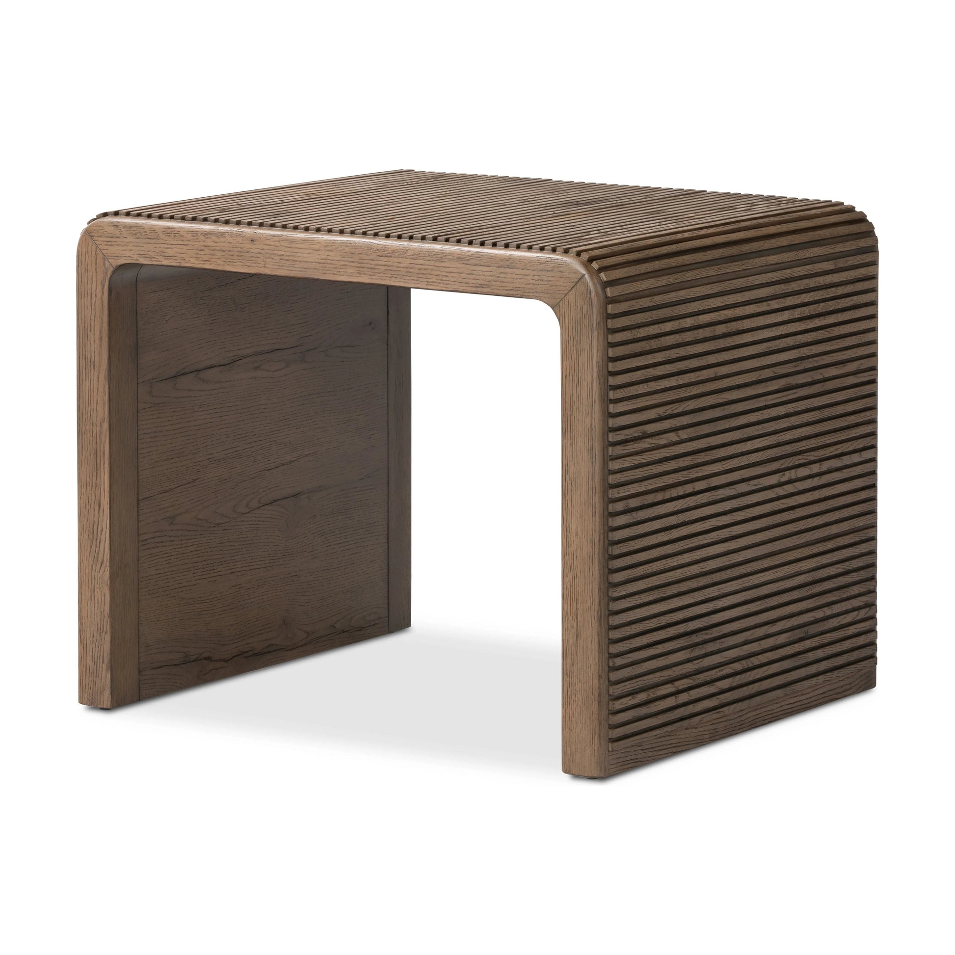 Made from rustic-finished oak, linear reeding and a curved shape define this midcentury-spirited end table. Designed in partnership with longtime Four Hands collaborator Thomas Bina and Brazilian designer Ronald Sasson.Collection: Bin Amethyst Home provides interior design, new home construction design consulting, vintage area rugs, and lighting in the Austin metro area.