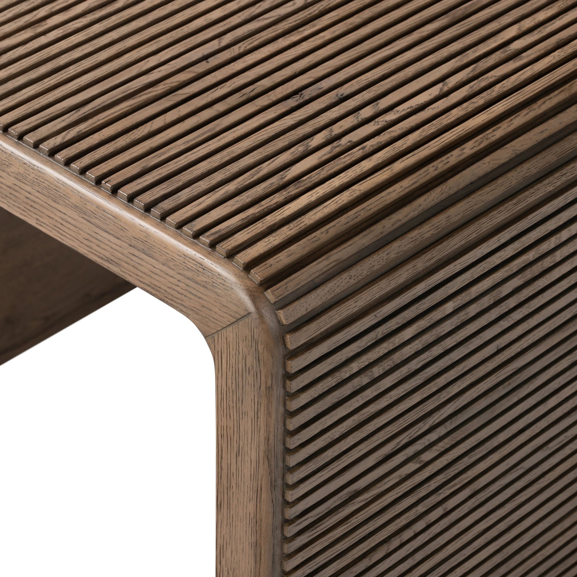 Made from rustic-finished oak, linear reeding and a curved shape define this midcentury-spirited end table. Designed in partnership with longtime Four Hands collaborator Thomas Bina and Brazilian designer Ronald Sasson.Collection: Bin Amethyst Home provides interior design, new home construction design consulting, vintage area rugs, and lighting in the Houston metro area.