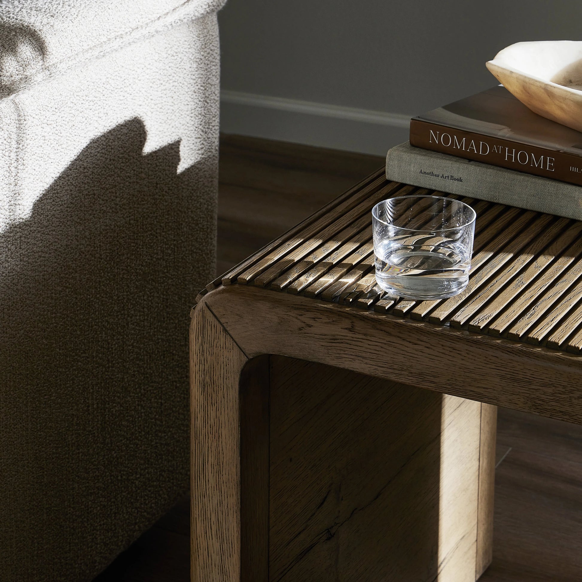 Made from rustic-finished oak, linear reeding and a curved shape define this midcentury-spirited end table. Designed in partnership with longtime Four Hands collaborator Thomas Bina and Brazilian designer Ronald Sasson.Collection: Bin Amethyst Home provides interior design, new home construction design consulting, vintage area rugs, and lighting in the Laguna Beach metro area.