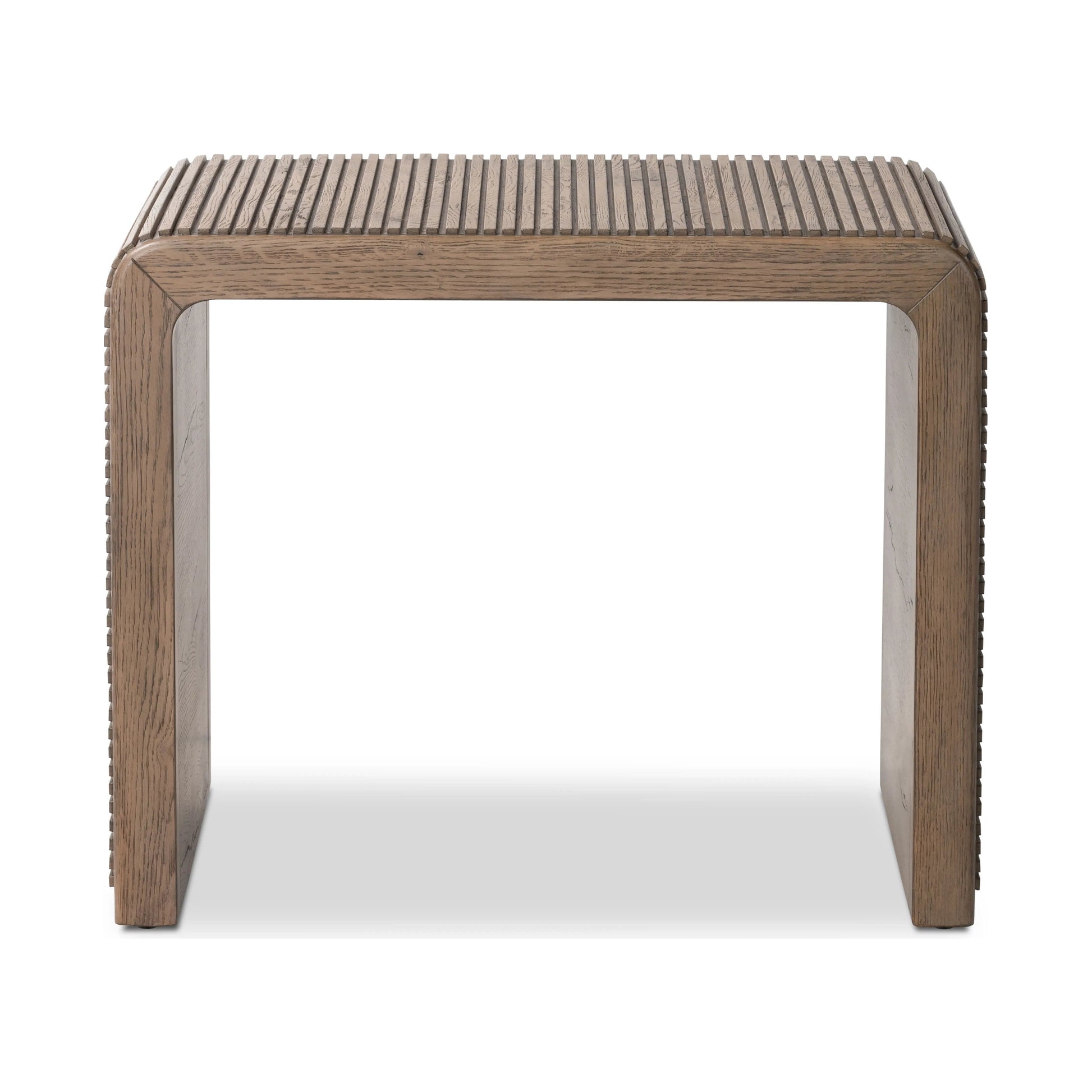 Made from rustic-finished oak, linear reeding and a curved shape define this midcentury-spirited end table. Designed in partnership with longtime Four Hands collaborator Thomas Bina and Brazilian designer Ronald Sasson.Collection: Bin Amethyst Home provides interior design, new home construction design consulting, vintage area rugs, and lighting in the San Diego metro area.