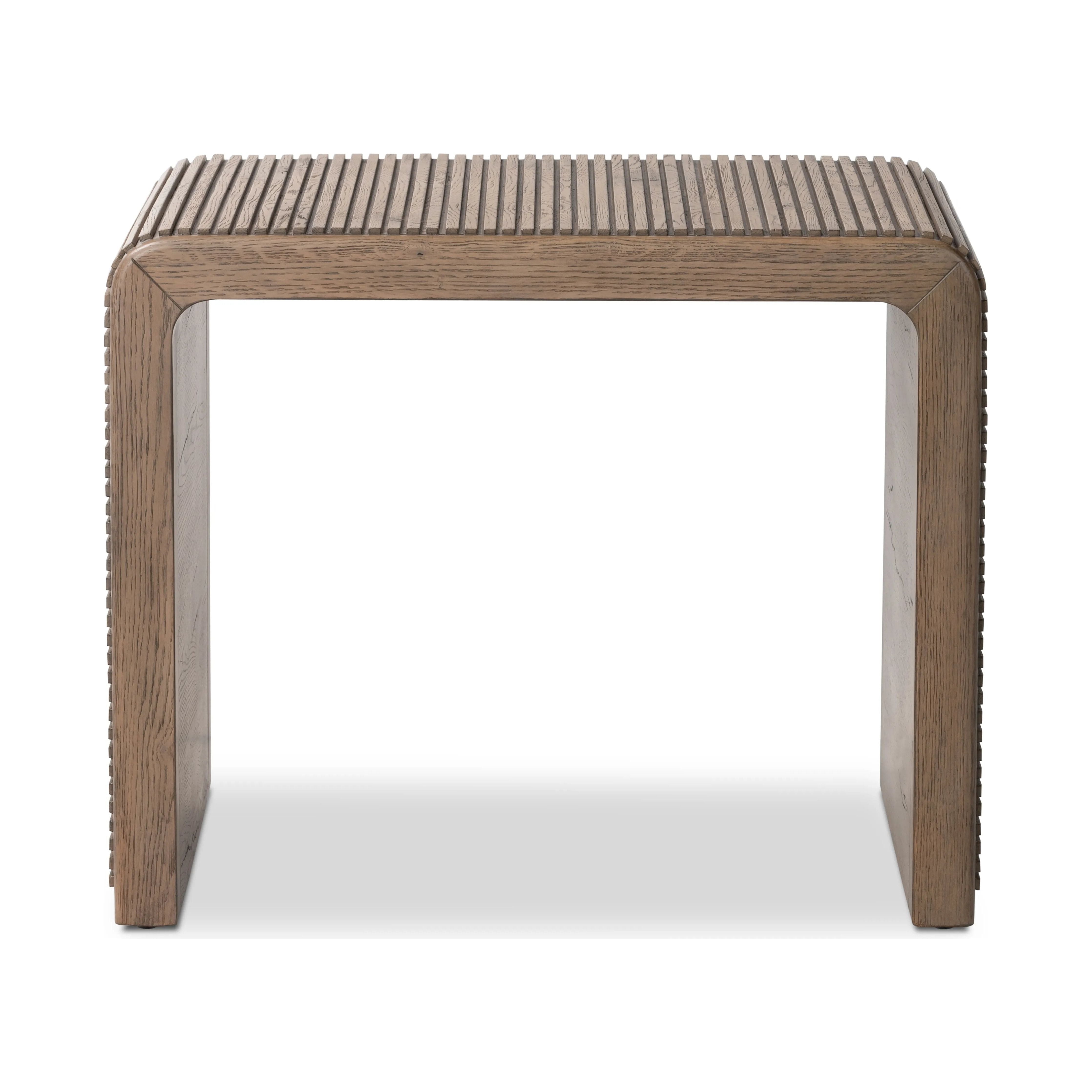 Made from rustic-finished oak, linear reeding and a curved shape define this midcentury-spirited end table. Designed in partnership with longtime Four Hands collaborator Thomas Bina and Brazilian designer Ronald Sasson.Collection: Bin Amethyst Home provides interior design, new home construction design consulting, vintage area rugs, and lighting in the San Diego metro area.