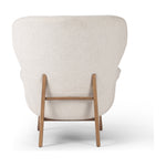 The classic wingback chair is updated with a midcentury-style base. Flared arms and a high winged back with blind tufting offer all-around comfort. Upholstered in a heavily textured boucle performance fabric bringing movement and everyday function to the piece. Amethyst Home provides interior design, new construction, custom furniture, and area rugs in the Des Moines metro area.