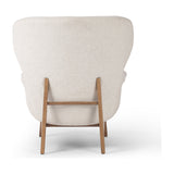 The classic wingback chair is updated with a midcentury-style base. Flared arms and a high winged back with blind tufting offer all-around comfort. Upholstered in a heavily textured boucle performance fabric bringing movement and everyday function to the piece. Amethyst Home provides interior design, new construction, custom furniture, and area rugs in the Des Moines metro area.