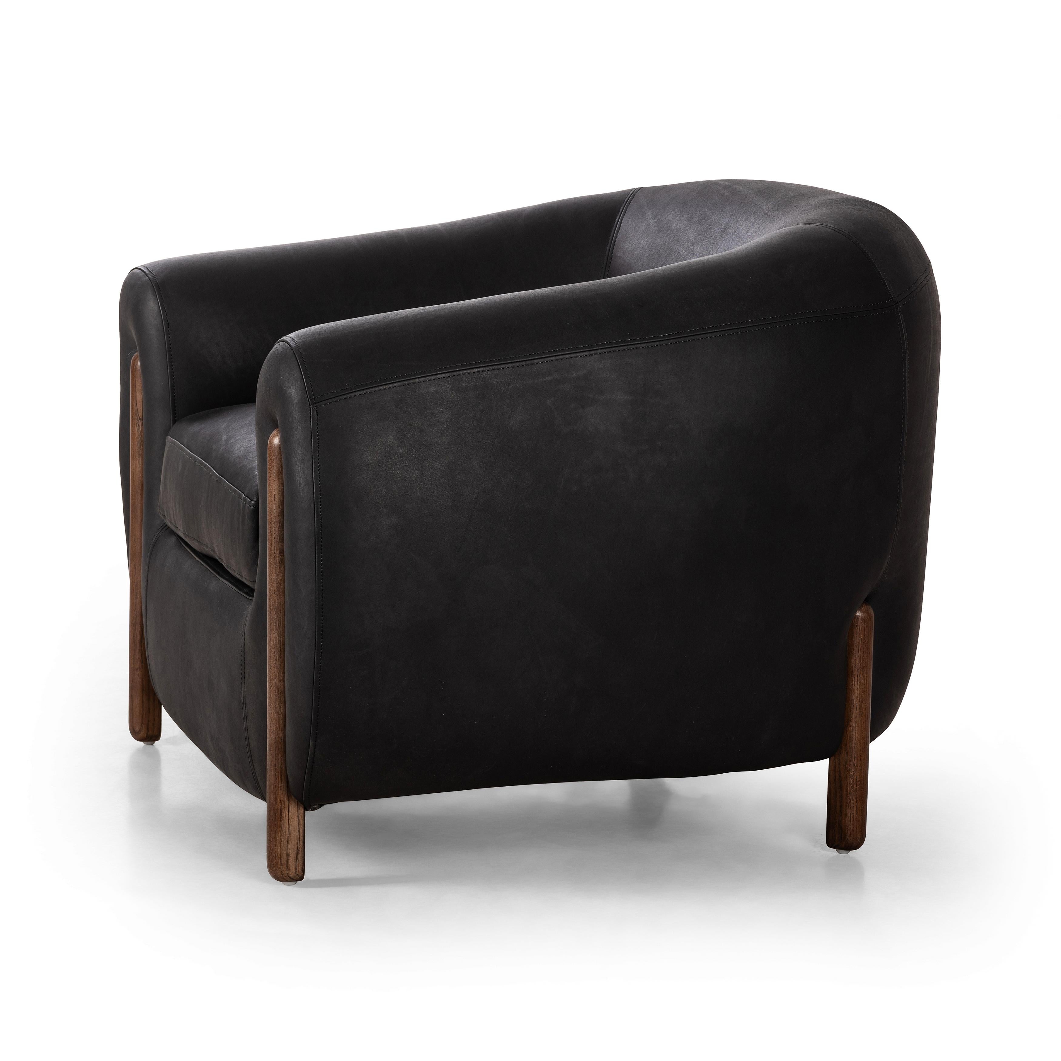Featuring Lyla Chair - Heirloom Black by Four Hands at Amethyst Home. This updated take on the traditional tub chair pairs rich black top-grain leather with solid ash to shape a sculpted seat with exaggerated depth. Sourced from one of the oldest family-owned tanneries in Italyâ€™s Bassano del Grappa, heirloom leather is salvaged and processed from upcycled hides featuring an ab. Amethyst Home provides interior design, new construction, custom furniture, and area rugs in the Scottsdale metro area.