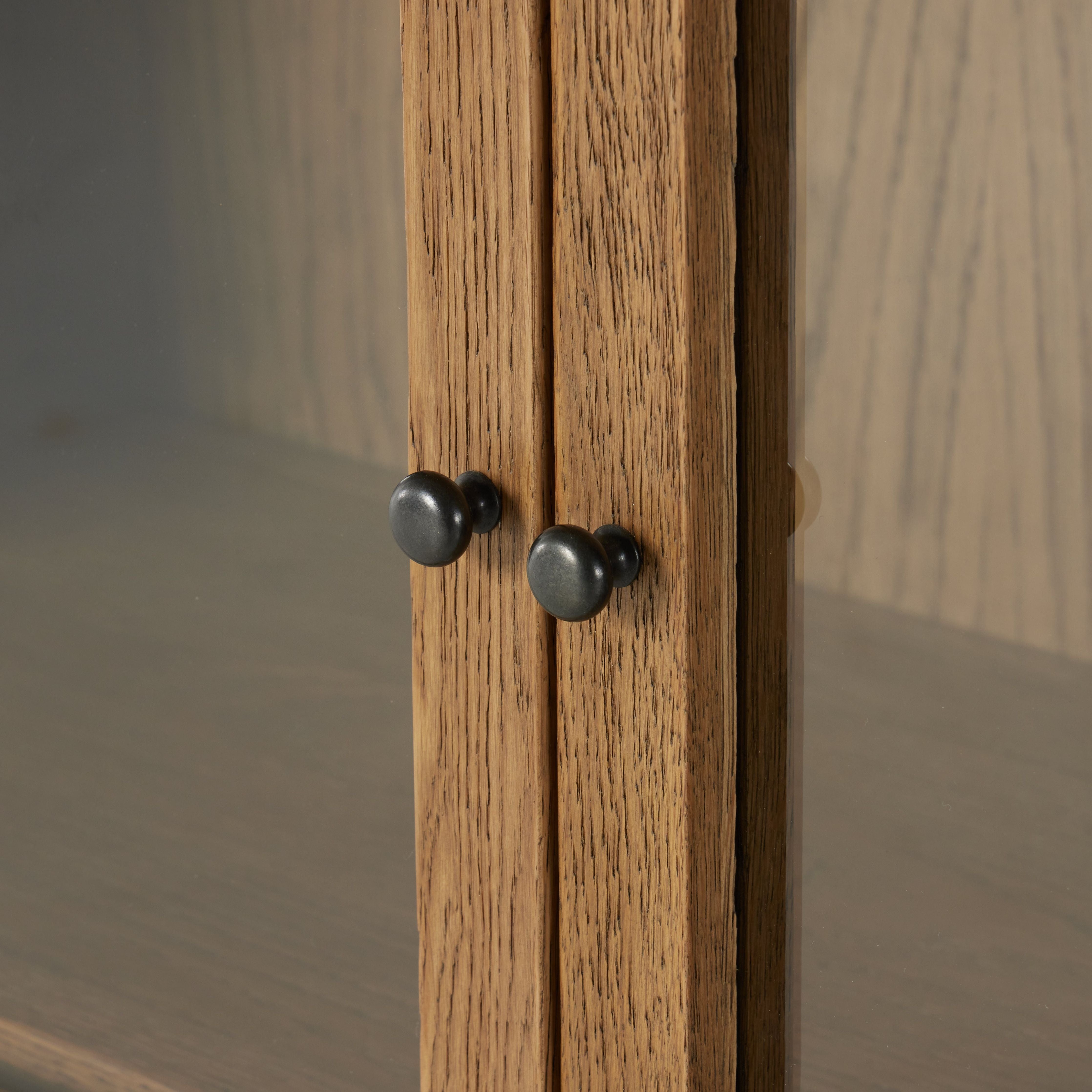 Drifted oak frames the interior shelving of this cabinet. Glass doors allow for prized possessions to dazzle on full display while spacious cabinets add out-of-view storage. Amethyst Home provides interior design, new construction, custom furniture, and area rugs in the Salt Lake City metro area.