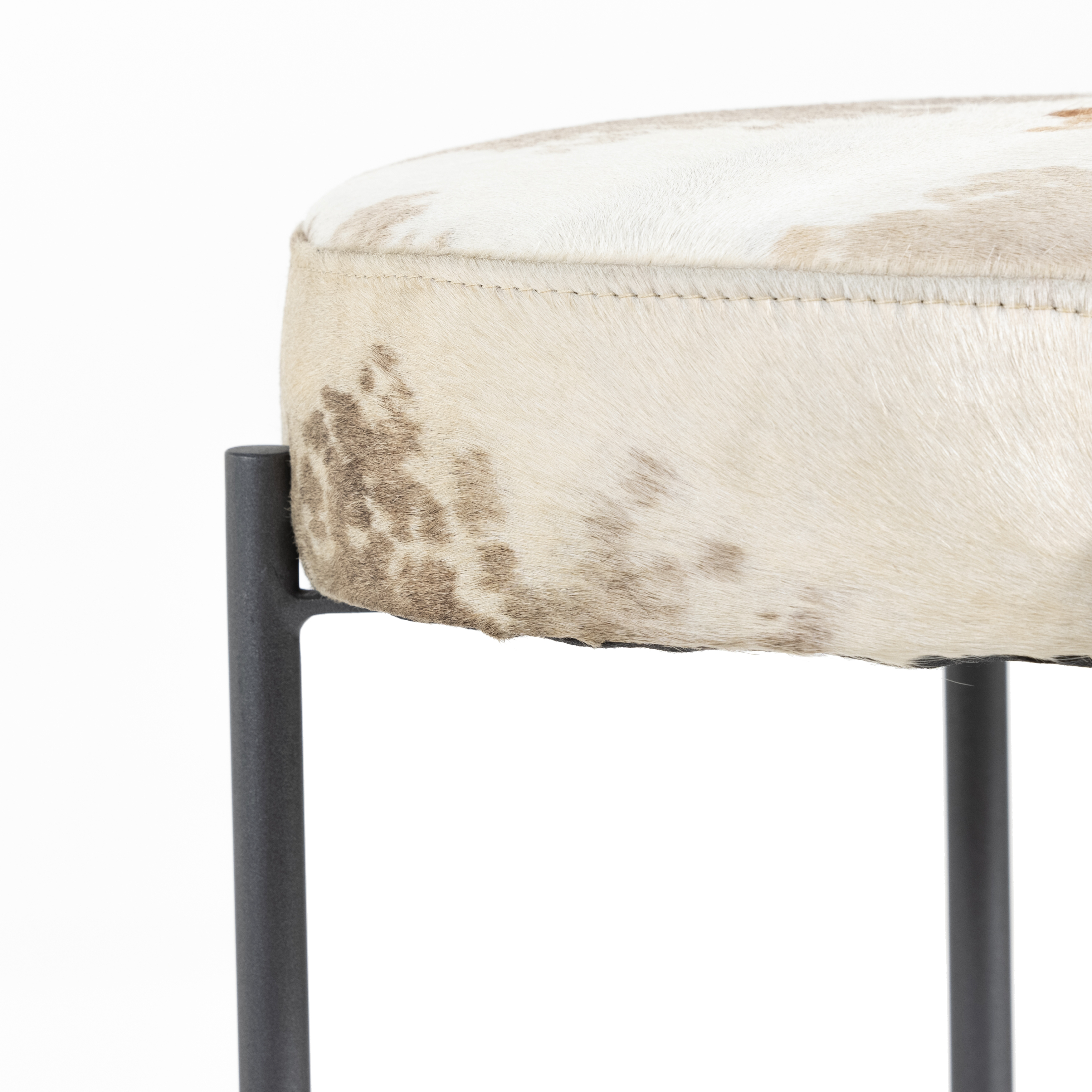 The Nocona Speckled Hide Bar and Counter stool is modern minimalist to a T. Slim and airy, gunmetal-finished iron legs form a cradle-style frame for speckled hide seating, perfectly sized for the counter or bar. Amethyst Home provides interior design, new construction, custom furniture, and rugs for the Atlanta metro area.