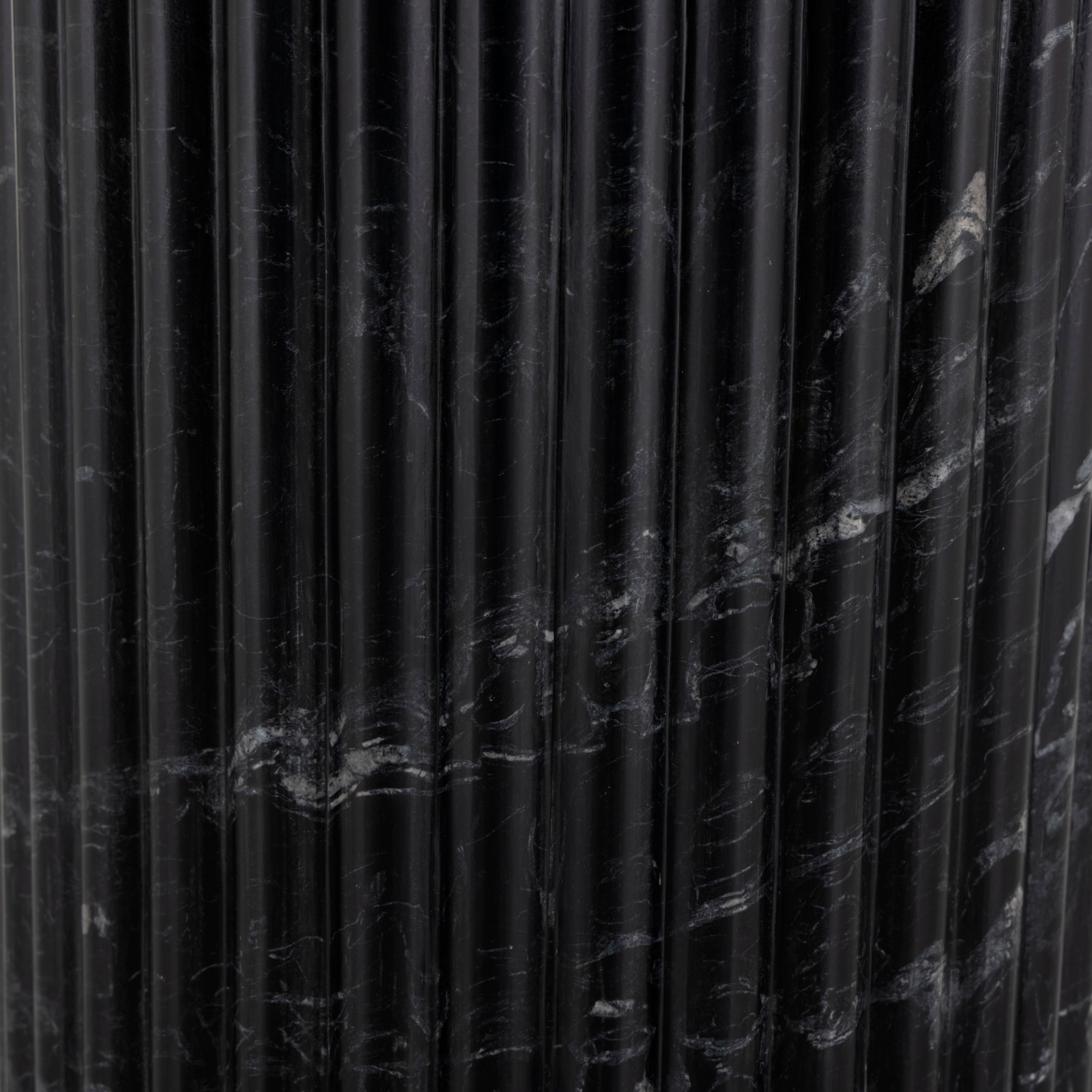 Inspired by Italian design, a swirling marble base is scalloped for a linear look with heavy texture. Topped with polished black marble. Amethyst Home provides interior design, new construction, custom furniture, and area rugs in the Tampa metro area.