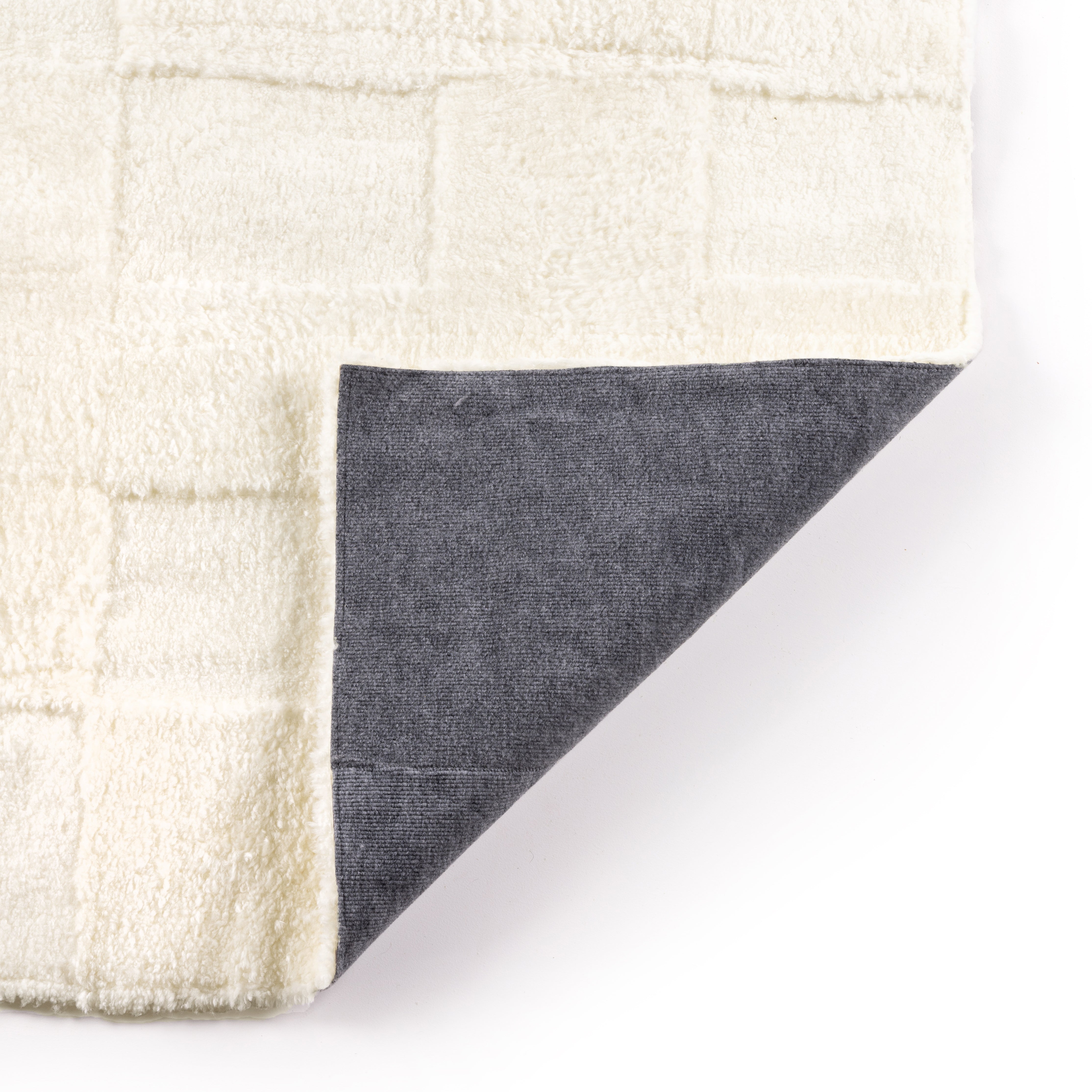 Patchwork Cream Shorn Shearling Rug is shaved to different heights and stitched together to create a tonal checked pattern for a modern yet classic look. Subtle color variations bring a natural, more organic feel to the rug. The material, pattern, and hues come together to craft an unexpected bold style. Amethyst Home provides interior design, new home construction design consulting, vintage area rugs, and lighting in the Seattle metro area.