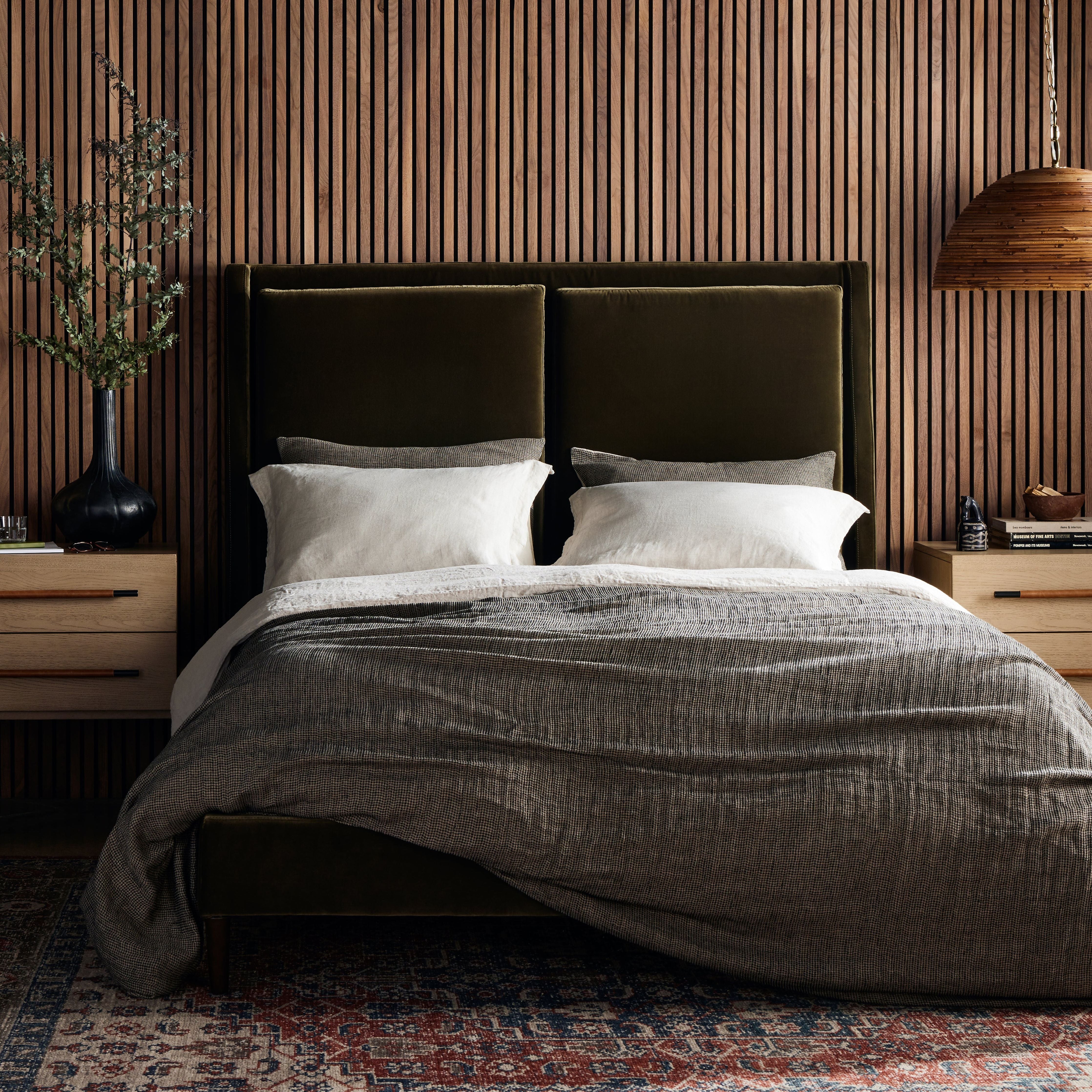 Upholstered in a velvety olive with subtle highs and lows that change in appearance depending on the direction of the fabric's nap. Fixed headboard cushioning for adds texture and comfort, while tapered oak legs lend a low-profile look. Amethyst Home provides interior design, new construction, custom furniture, and area rugs in the Laguna Beach metro area.