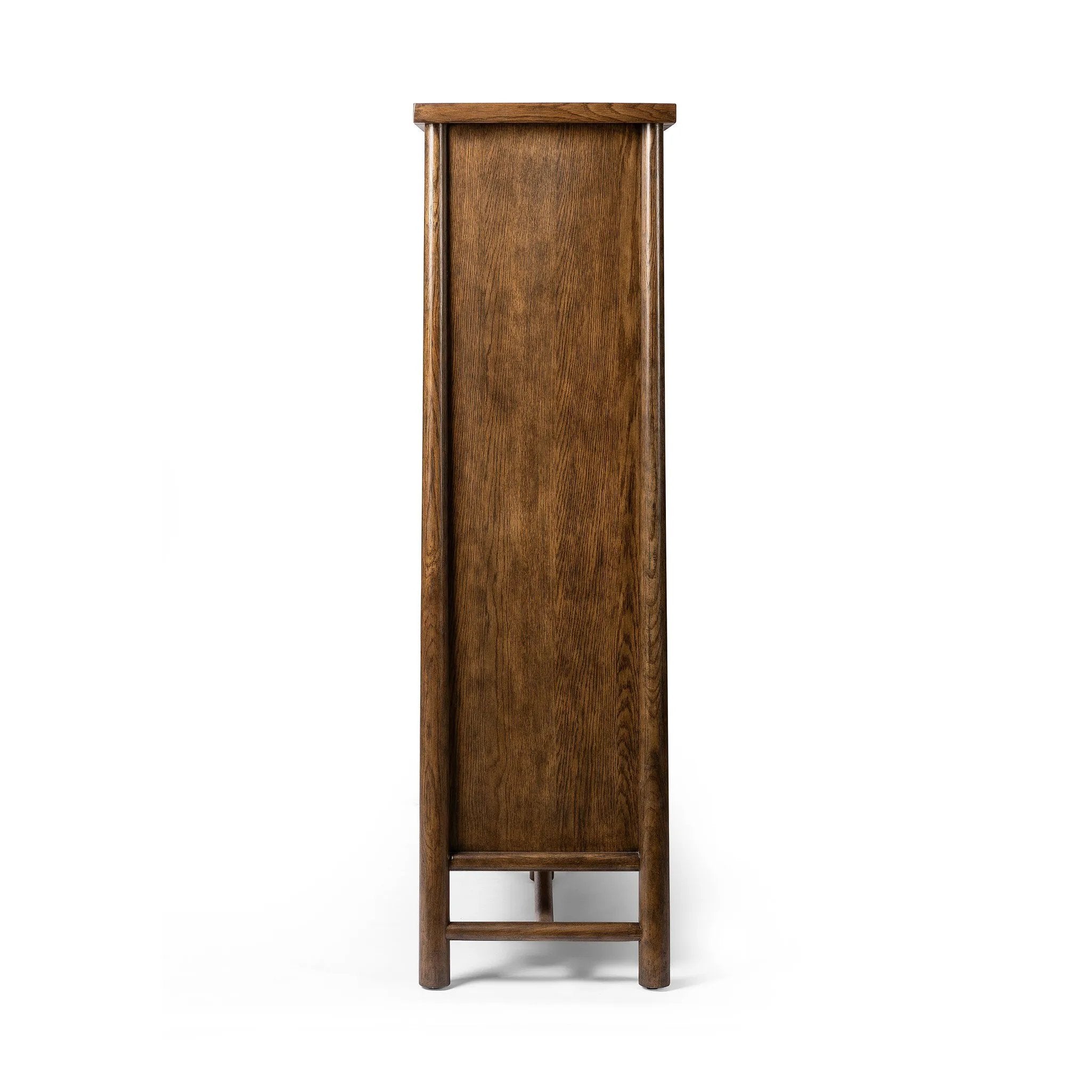 A beautifully simple statement piece. This three-door cabinet is crafted from a mix of solid oak and veneer in a dark toasted finish. Details include subtle, tapered corner posts and minimal rounded door knobs.Collection: Well Amethyst Home provides interior design, new home construction design consulting, vintage area rugs, and lighting in the Dallas metro area.