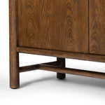 A beautifully simple statement piece. This three-door cabinet is crafted from a mix of solid oak and veneer in a dark toasted finish. Details include subtle, tapered corner posts and minimal rounded door knobs.Collection: Well Amethyst Home provides interior design, new home construction design consulting, vintage area rugs, and lighting in the Los Angeles metro area.