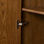 A beautifully simple statement piece. This three-door cabinet is crafted from a mix of solid oak and veneer in a dark toasted finish. Details include subtle, tapered corner posts and minimal rounded door knobs.Collection: Well Amethyst Home provides interior design, new home construction design consulting, vintage area rugs, and lighting in the Newport Beach metro area.