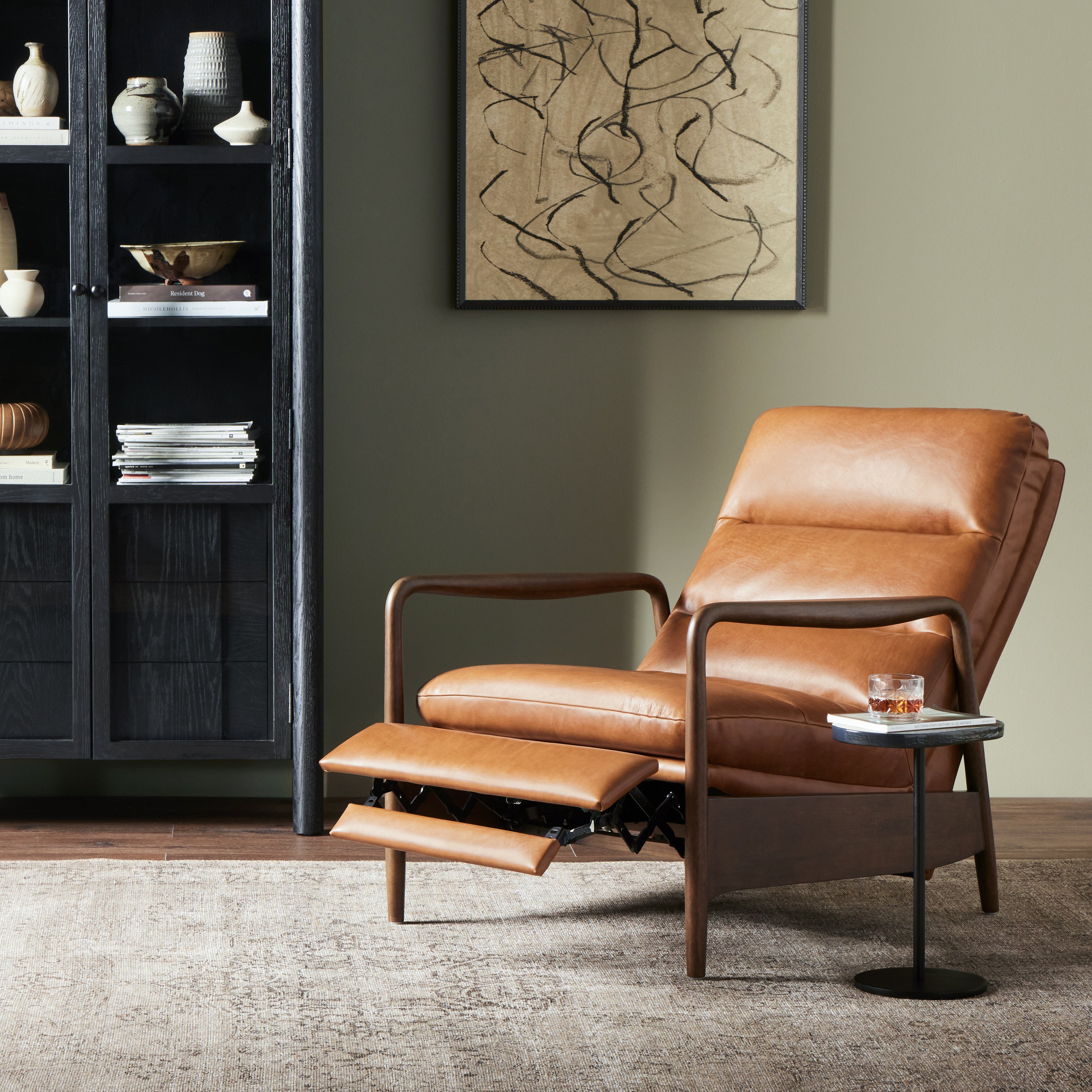 A sleek seat with hidden push-back reclining functionality. This midcentury-inspired recliner features wide chunky channeling paired with slim paddle arms and a tapered wood frame. Designed with a high seat and high back for extra comfy support. Upholstered in a timeless tobacco-hued leather made in a family-owned tannery in Thailand. Amethyst Home provides interior design, new construction, custom furniture, and area rugs in the Des Moines metro area.