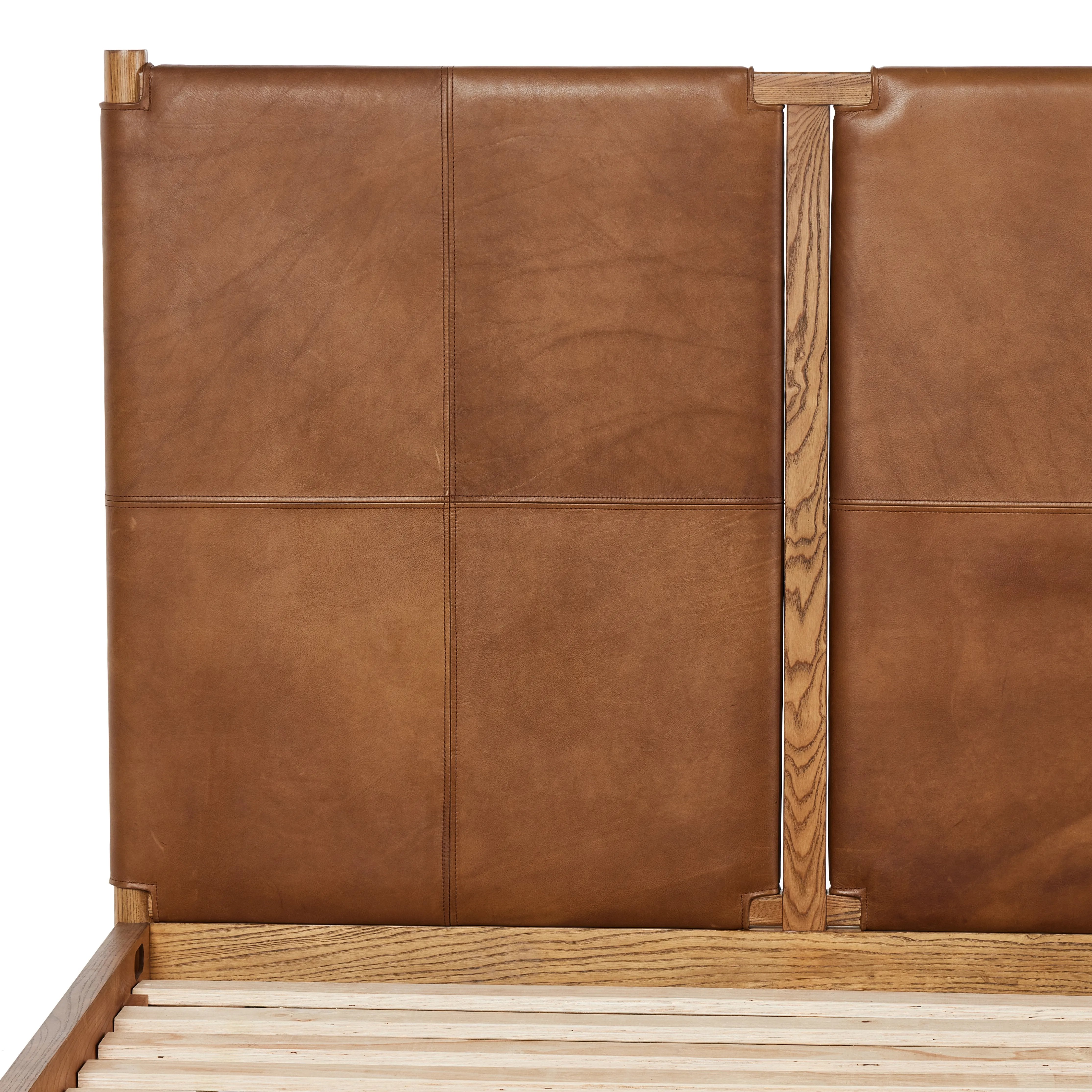 Solid ash framing and heirloom leather panel details craft this safari-inspired bed frame. Sourced from one of the oldest family-owned tanneries in Italyâ€™s Bassano del Grappa, our heirloom leather covering is salvaged and processed from upcycled hides featuring an abundance of natural markings, scars and color variations. Amethyst Home provides interior design, new home construction design consulting, vintage area rugs, and lighting in the Nashville metro area.