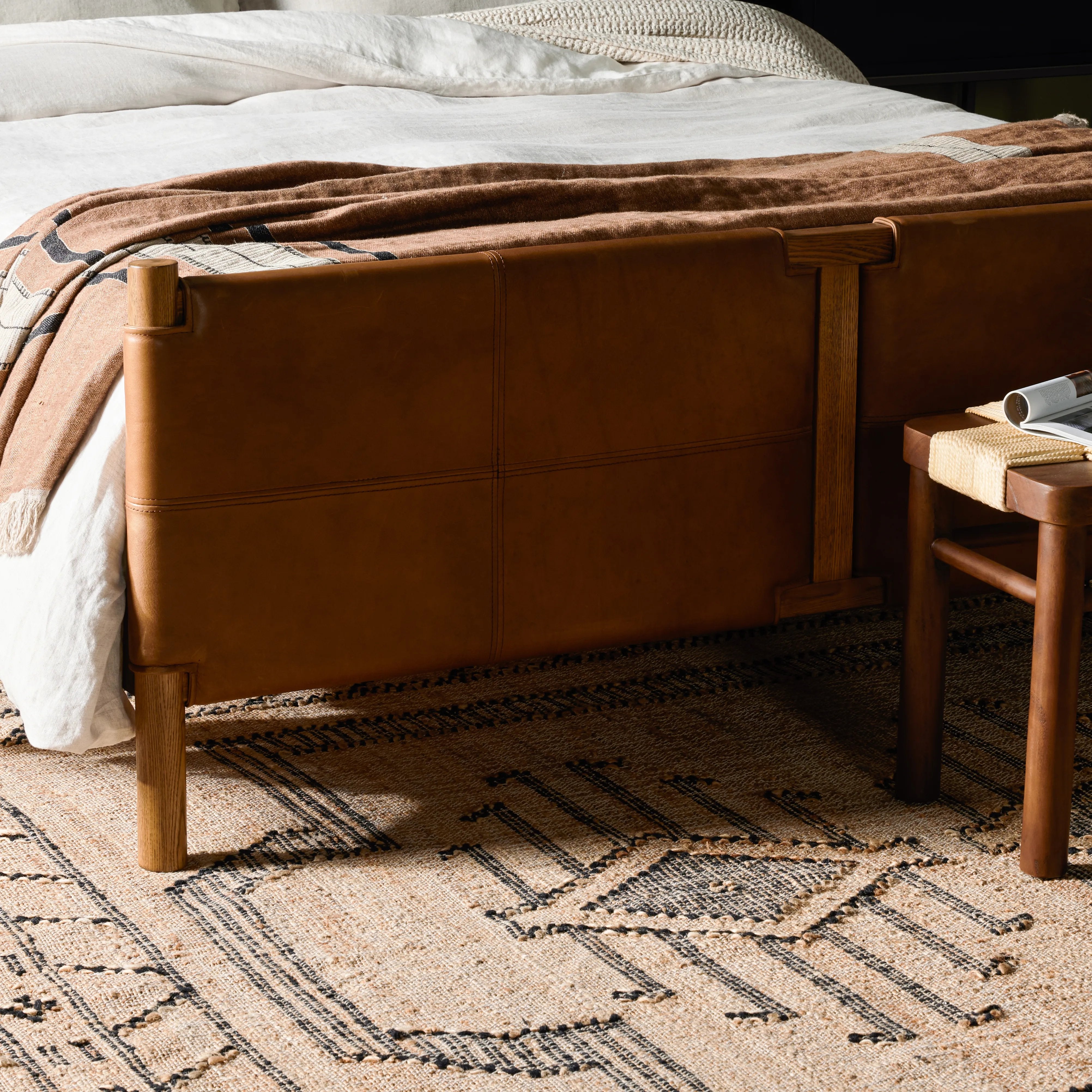 Solid ash framing and heirloom leather panel details craft this safari-inspired bed frame. Sourced from one of the oldest family-owned tanneries in Italyâ€™s Bassano del Grappa, our heirloom leather covering is salvaged and processed from upcycled hides featuring an abundance of natural markings, scars and color variations. Amethyst Home provides interior design, new home construction design consulting, vintage area rugs, and lighting in the Newport Beach metro area.