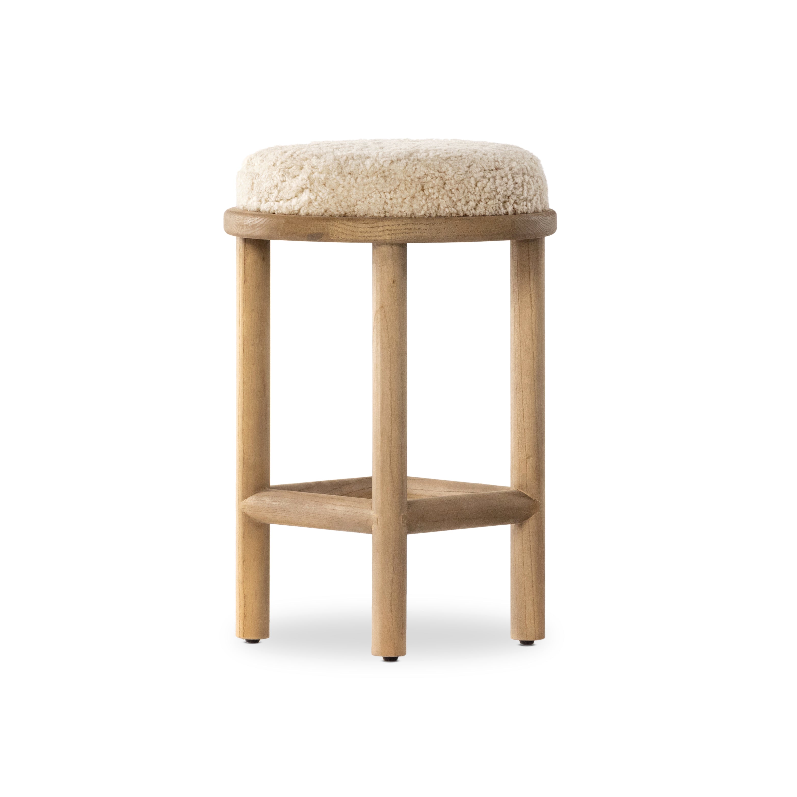 Bring a textural touch to the counter with the Saldino stool. Blonde-finished solid parawood supports rounded seating of soft beige shearling for comfort and style alike. Amethyst Home provides interior design, new home construction design consulting, vintage area rugs, and lighting in the Alpharetta metro area.