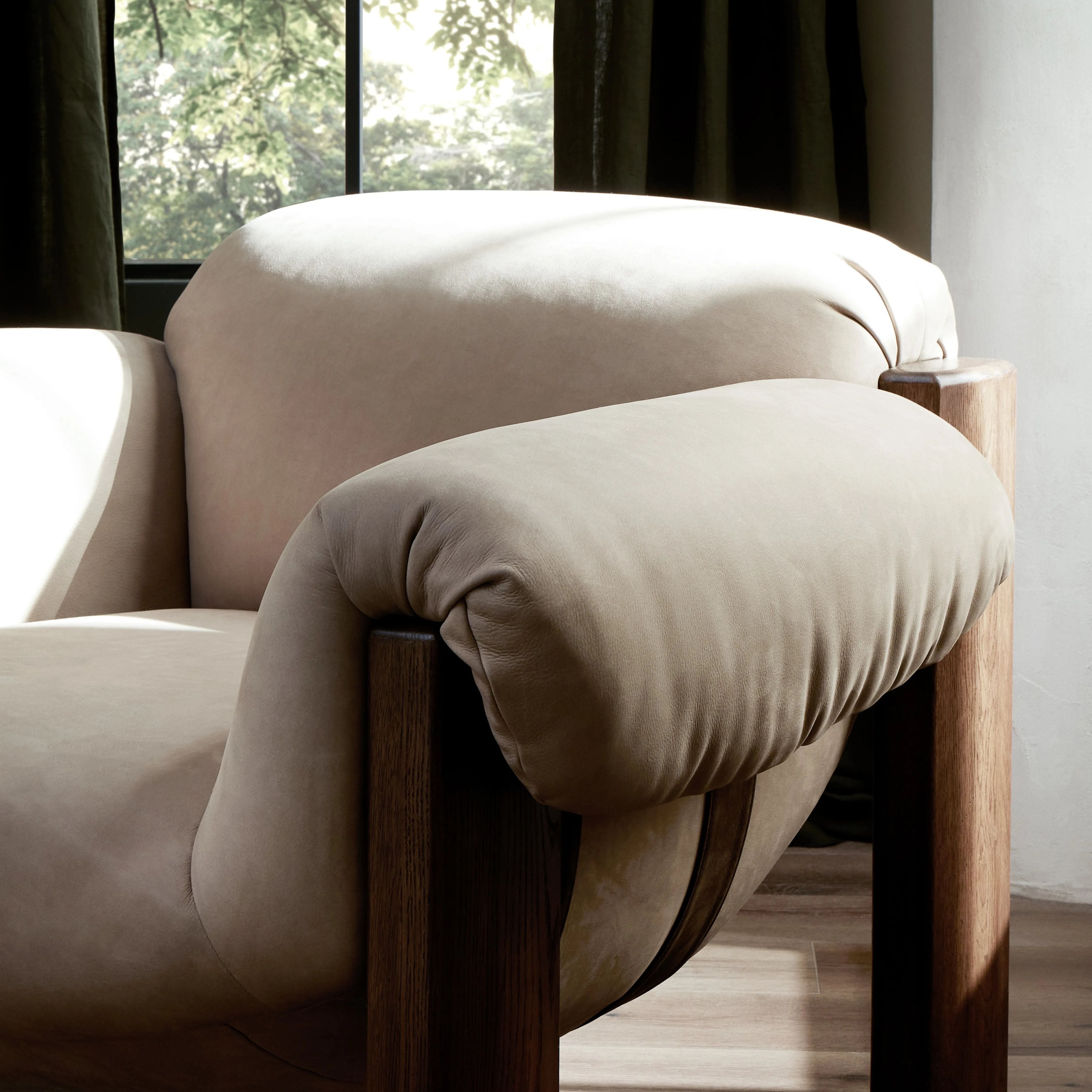 Featuring Samena Nubuck Sand Chair by Four Hands at Amethyst Home. A cozy spot for lounging and curling up with a good book. This statement-making chair features large overflowing cushioning that wraps around the arms and back. Designed with S spring construction and a solid oak frame. Upholstered in a smooth sueded leather with contrasting sling seati. Amethyst Home provides interior design, new home construction design consulting, vintage area rugs, and lighting in the Salt Lake City metro area.
