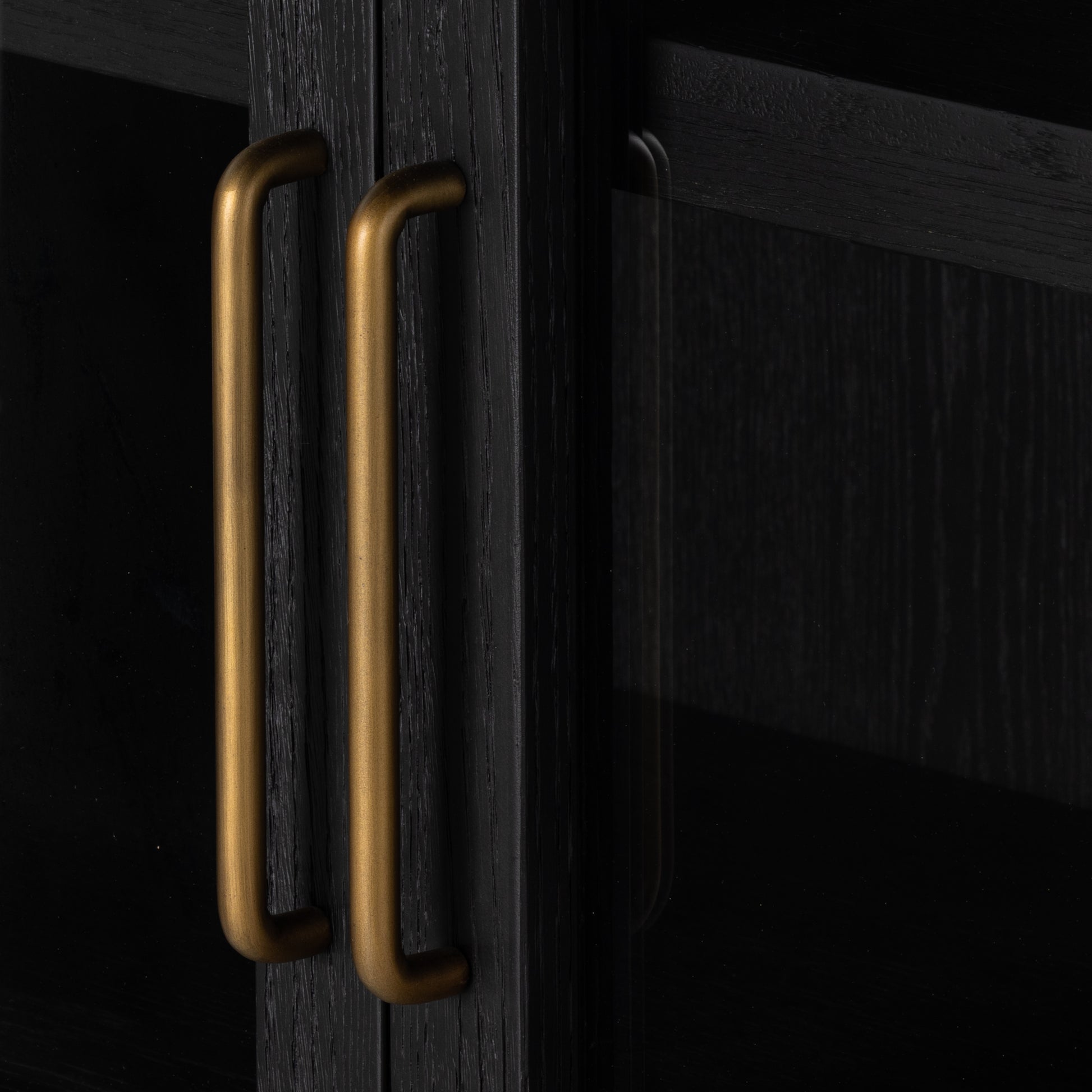 Made from black-finished solid oak, French-inspired cabinetry features an arched top, spacious interior and a clear glass front for storage and display. Amethyst Home provides interior design, new construction, custom furniture, and area rugs in the Nashville metro area.