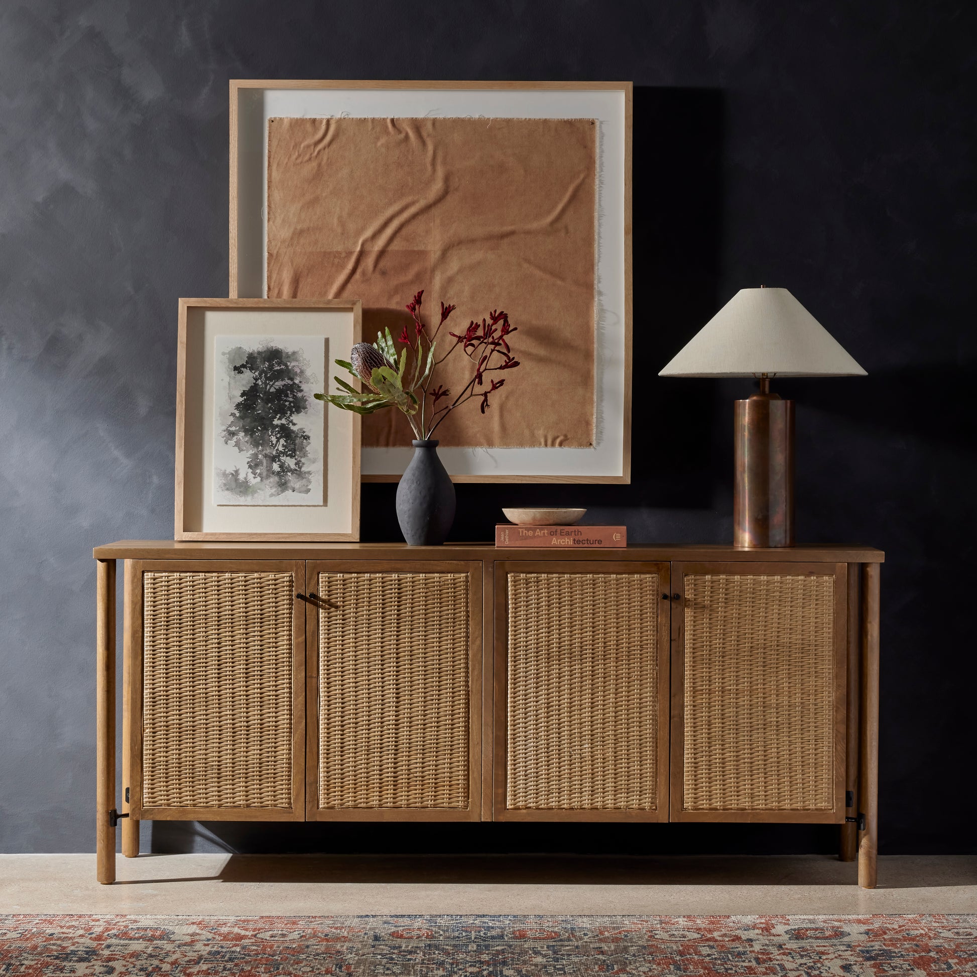 The Veta Taupe Cane Sideboard's modern weave pattern refreshes an ever-trending material. Solid mango encases cane door fronts with a unique taupe finish and textural basket weave. Dowel legs separate from casing for a float-like look. Spacious interior perfect for storing table linens and serveware. Amethyst Home provides interior design services, furniture, rugs, and lighting in the Dallas metro area. 