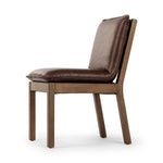 Inspired by the folded pillow form, the seat and back cushions of this oak dining chair are covered in brown top-grain leather. The chair back features leather strap details for a mixed material touch.Collection: Ashfor Amethyst Home provides interior design, new home construction design consulting, vintage area rugs, and lighting in the Scottsdale metro area.